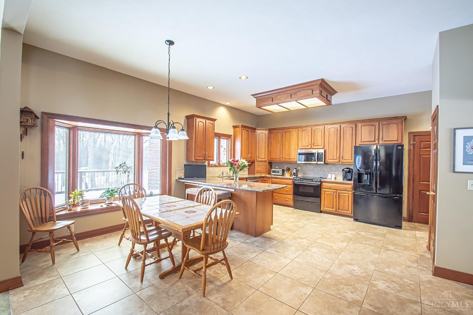 The eat in kitchen has tile flooring, a bay window and wood cabinets. It also has a planning desk and pantry.