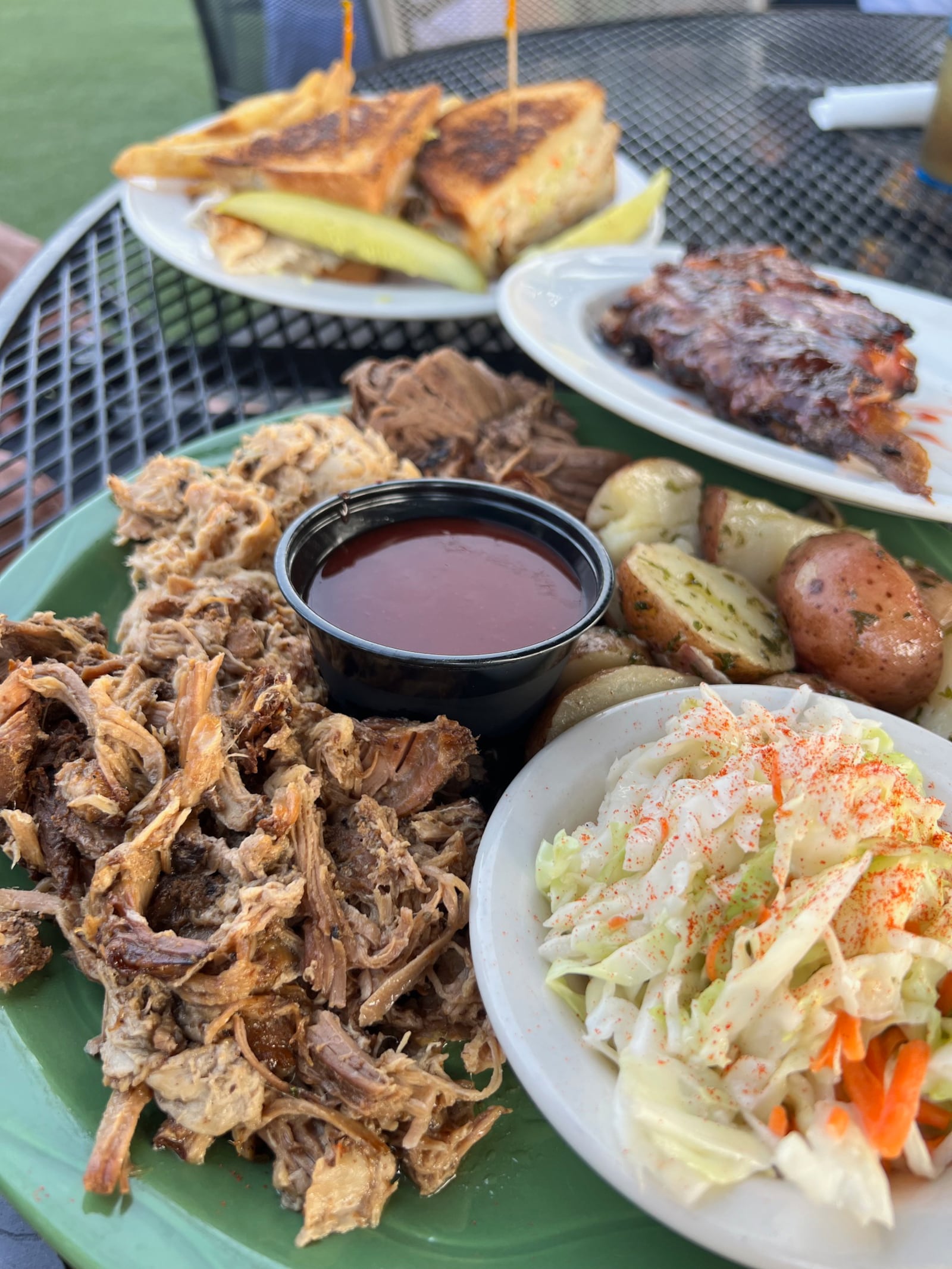 BBQ combo ($18) featuring pulled pork, chicken and brisket with an optional add of three baby back ribs for $7