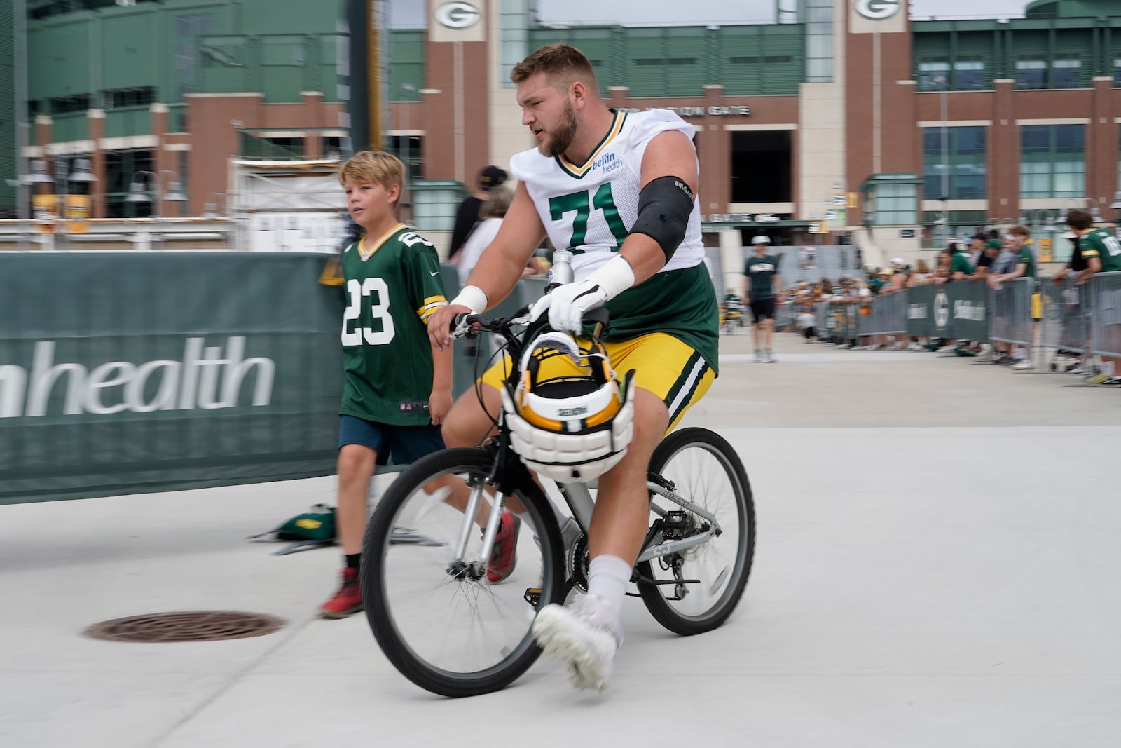 Green Bay Packers' Josh Myers rides a bike to the NFL football team's practice field Wednesday, July 27, 2022, in Green Bay, Wis. (AP Photo/Morry Gash)