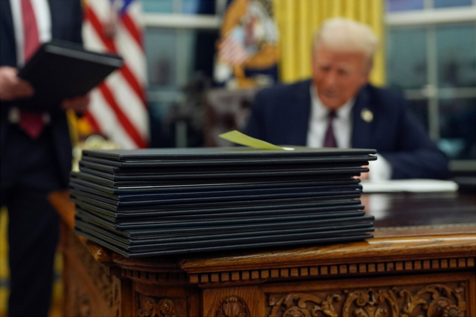 FILE - President Donald Trump signs executive orders in the Oval Office of the White House, Jan. 20, 2025, in Washington. (AP Photo/Evan Vucci, File)