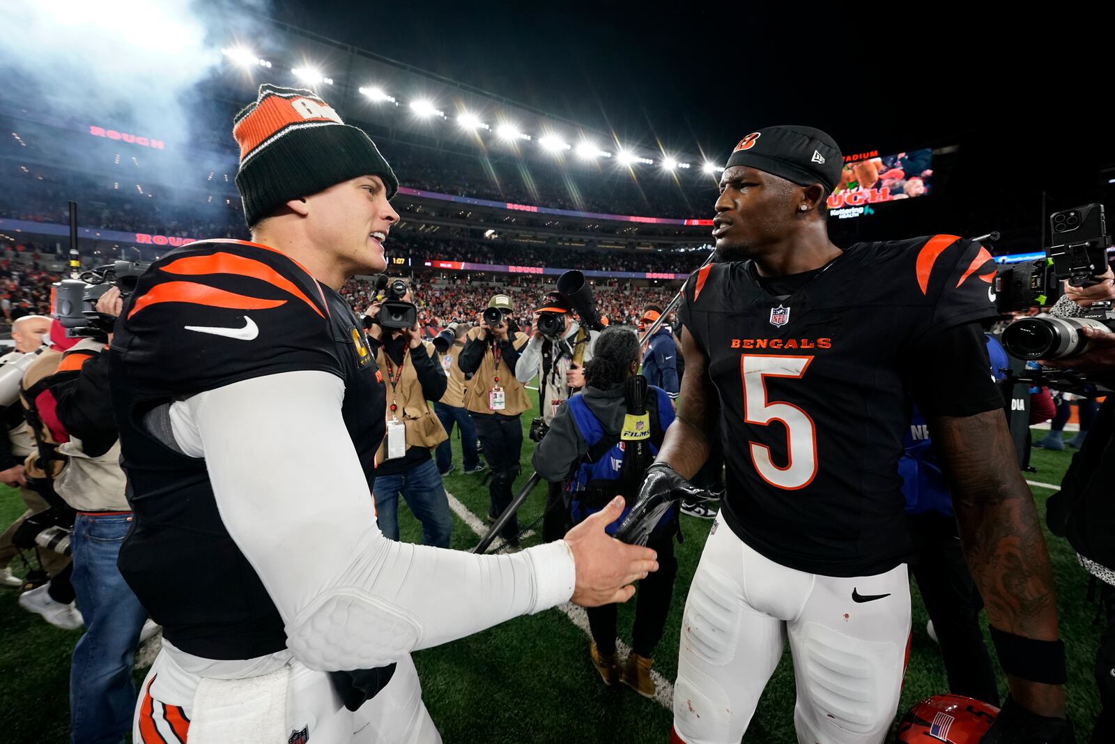 Cincinnati Bengals quarterback Joe Burrow (9) celebrates with wide receiver Tee Higgins (5) after an NFL football game against the Denver Broncos in Cincinnati, Saturday, Dec. 28, 2024. (AP Photo/Jeff Dean)