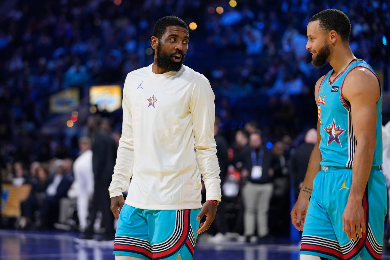 Dallas Mavericks guard Kyrie Irving, left, talks to Golden State Warriors guard Stephen Curry during the NBA All-Star basketball game Sunday, Feb. 16, 2025, in San Francisco. (AP Photo/Godofredo A. Vásquez)