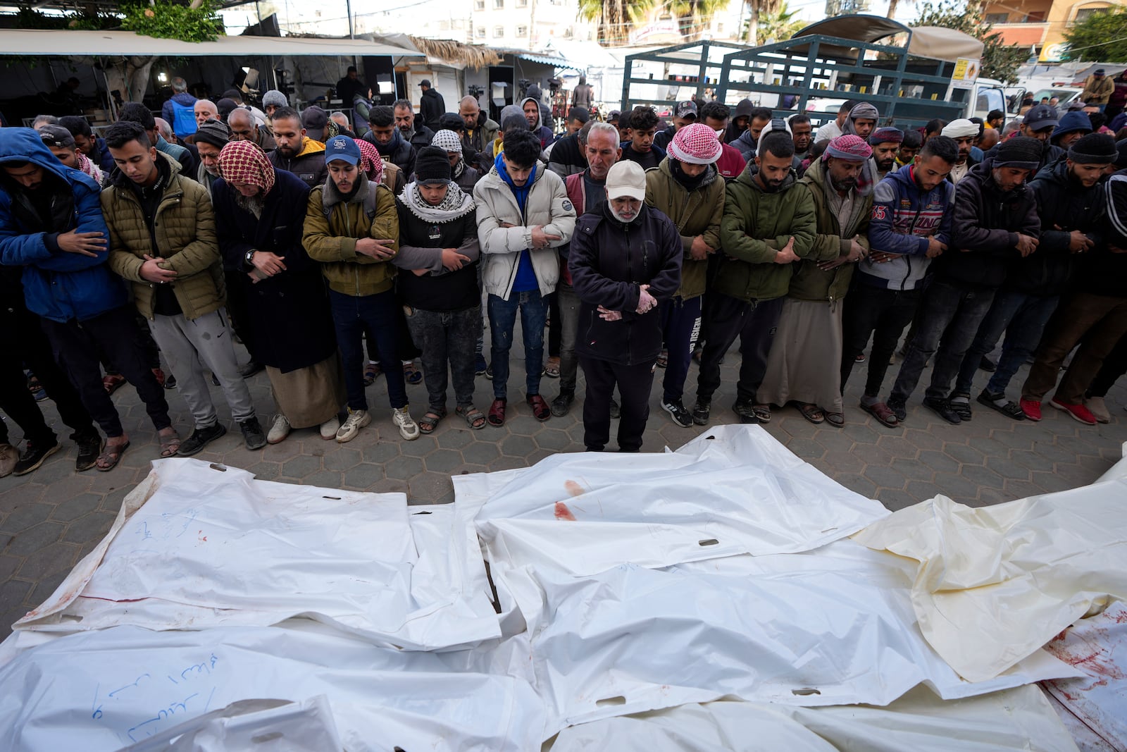 Palestinians attend funeral prayers over the bodies of those killed in overnight Israeli airstrikes on the Maghazi refugee camp, at Al-Aqsa Hospital, in Deir al-Balah, central Gaza Strip, Saturday, Dec. 28, 2024. (AP Photo/Abdel Kareem Hana)