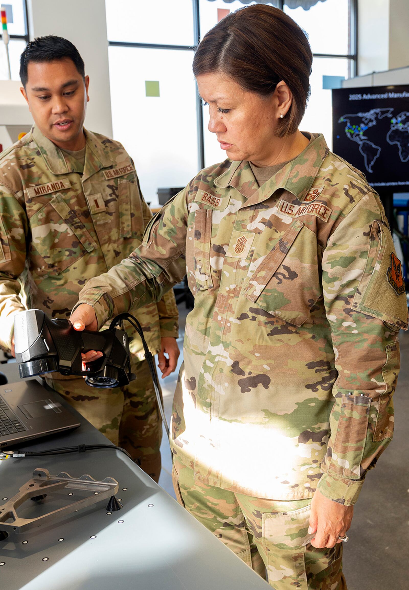 Second Lt. Lewis Miranda (left), Air Force Life Cycle Management Center Rapid Sustainment Office Advance Manufacturing Program, briefs Chief Master Sgt. of the Air Force JoAnne S. Bass on the digital scanning of parts for use in computer assisted design and 3D printing. U.S. AIR FORCE PHOTO/R.J. ORIEZ