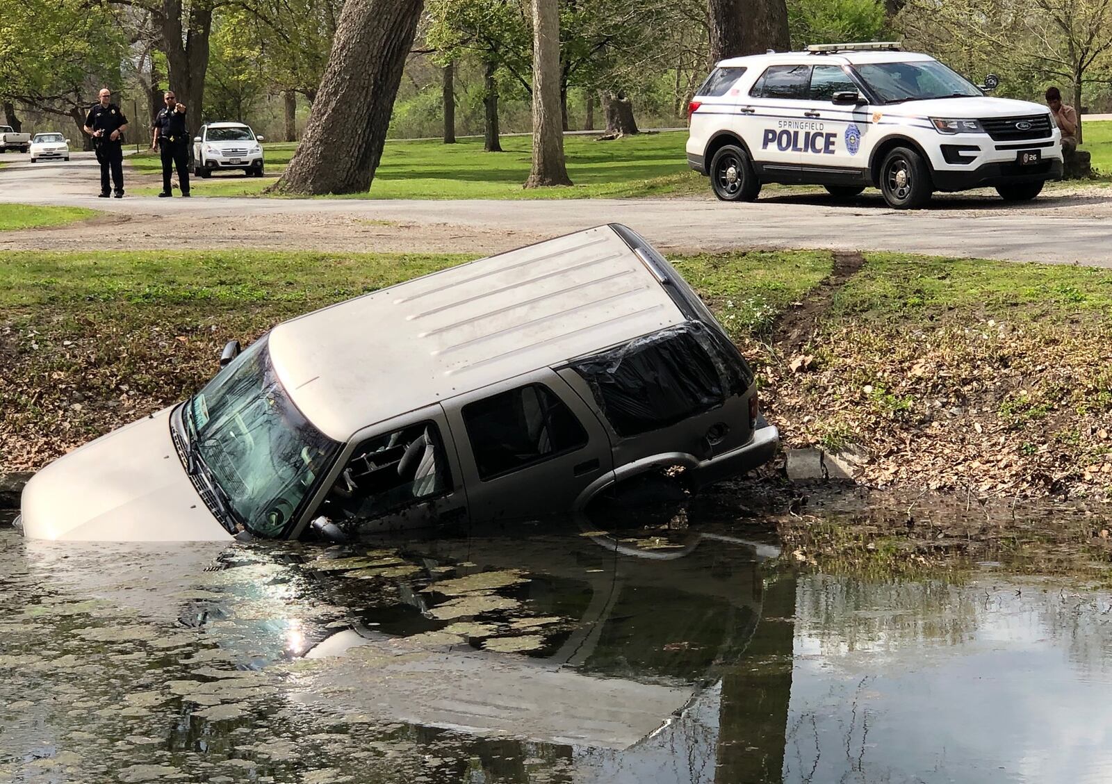 An SUV crashed into a pond at Snyder Park after Springfield police said the driver over-corrected. No one was hurt in the crash Tuesday, April, 28, 2020. BILL LACKEY / STAFF