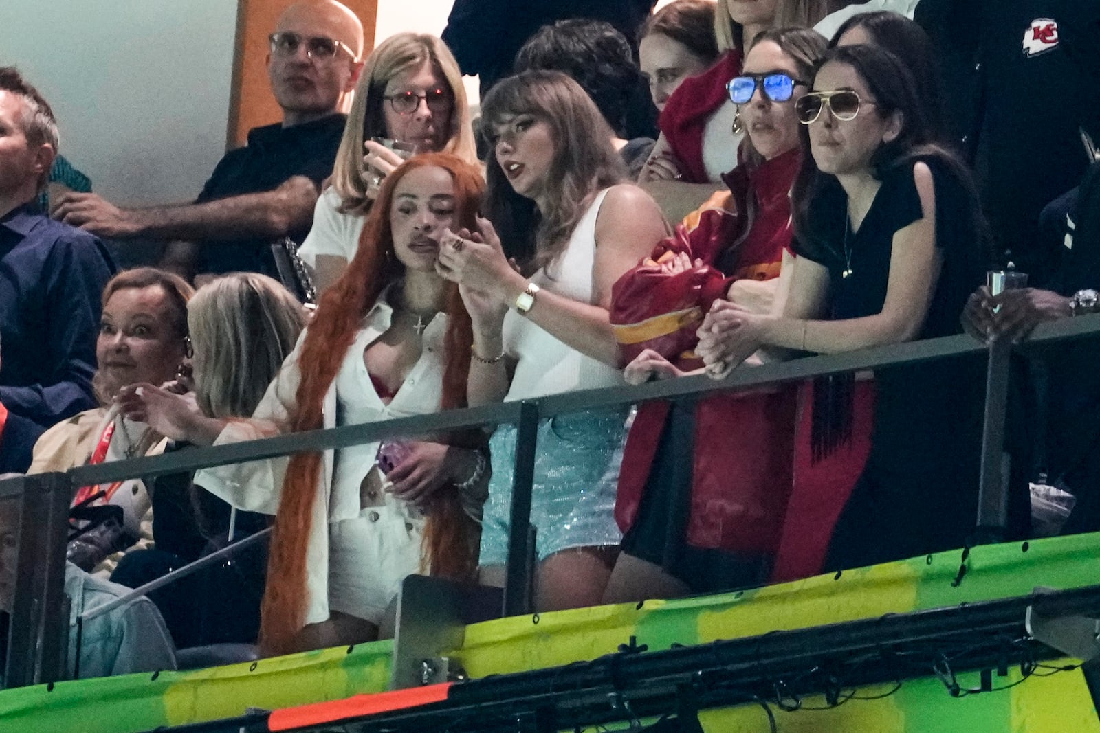 Ice Spice, from left, Taylor Swift, Este Haim and Alana Haim watch during the first half of the NFL Super Bowl 59 football game between the Kansas City Chiefs and the Philadelphia Eagles, Sunday, Feb. 9, 2025, in New Orleans. (AP Photo/Gerald Herbert)