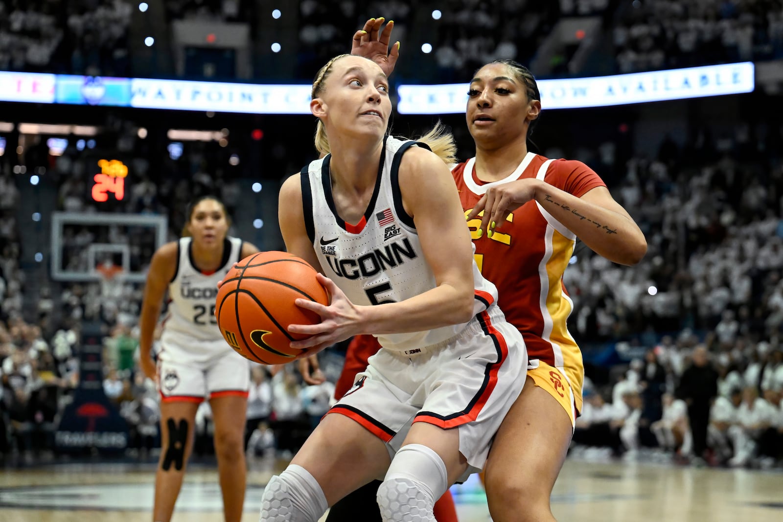 UConn guard Paige Bueckers is guarded by USC guard Kennedy Smith, right, in the first half of an NCAA college basketball game, Saturday, Dec. 21, 2024, in Hartford, Conn. (AP Photo/Jessica Hill)