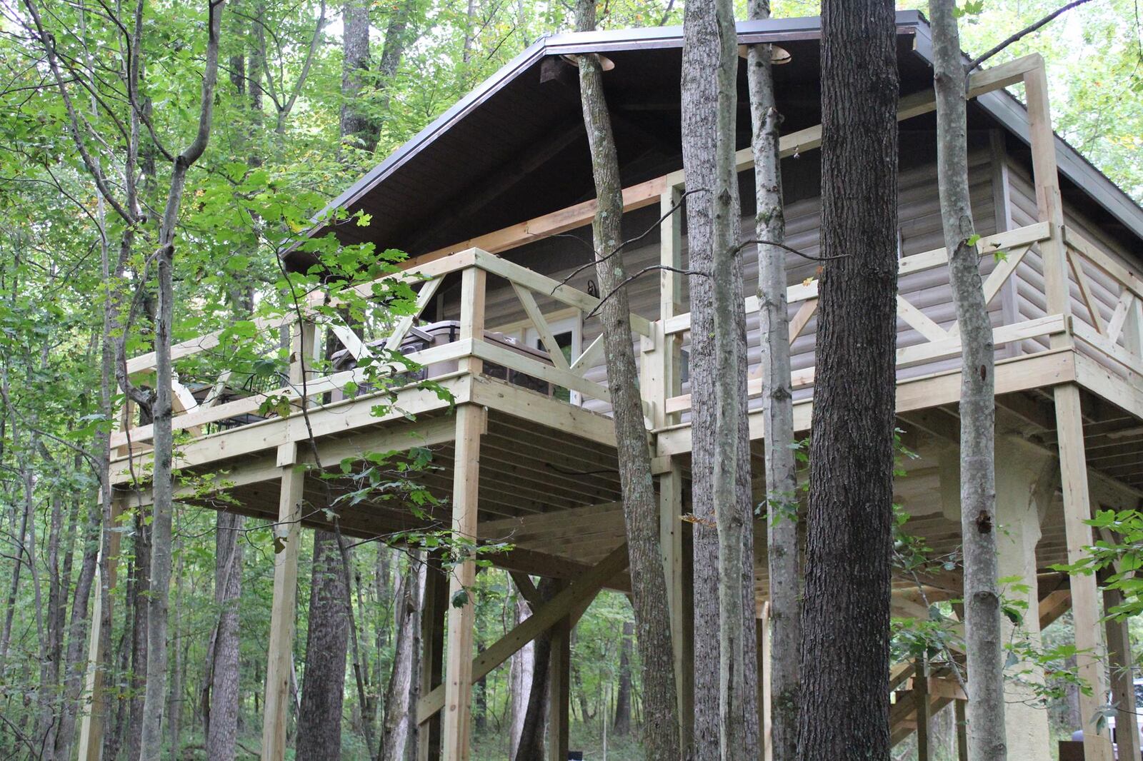 The Comfort in the Woods Treehouse offers unrivaled stargazing from the hot tub situated its wraparound deck. It is a cozy cabin near a stream with room for two people. CONTRIBUTED