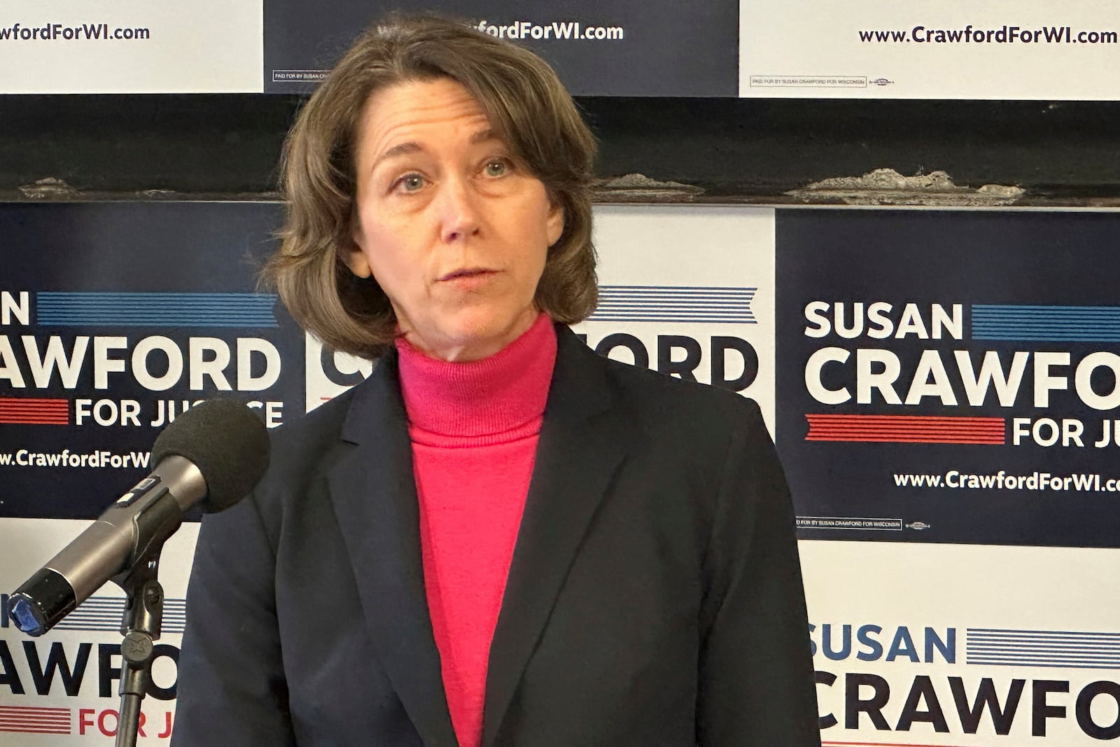 Wisconsin Supreme Court candidate Susan Crawford takes questions at a news conference, Tuesday, Feb. 25, 2025, in Madison, Wisconsin. (AP Photo/Scott Bauer)