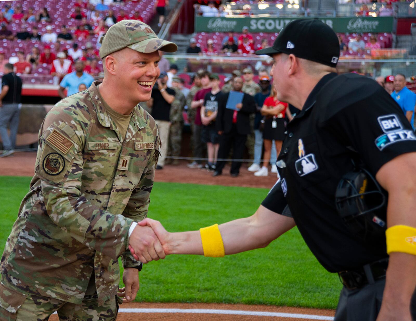 Capt. Andrew Fenner, Air Force Institute of Technology, shakes hands with umpire Nick Mahrley at the start of a Major League Baseball game between the Cincinnati Reds and the Colorado Rockies Sept. 2 at Great American Ball Park in Cincinnati. Fenner was named the honorary game captain as part of the Reds’ annual military appreciation night. U.S. AIR FORCE PHOTO/R.J. ORIEZ