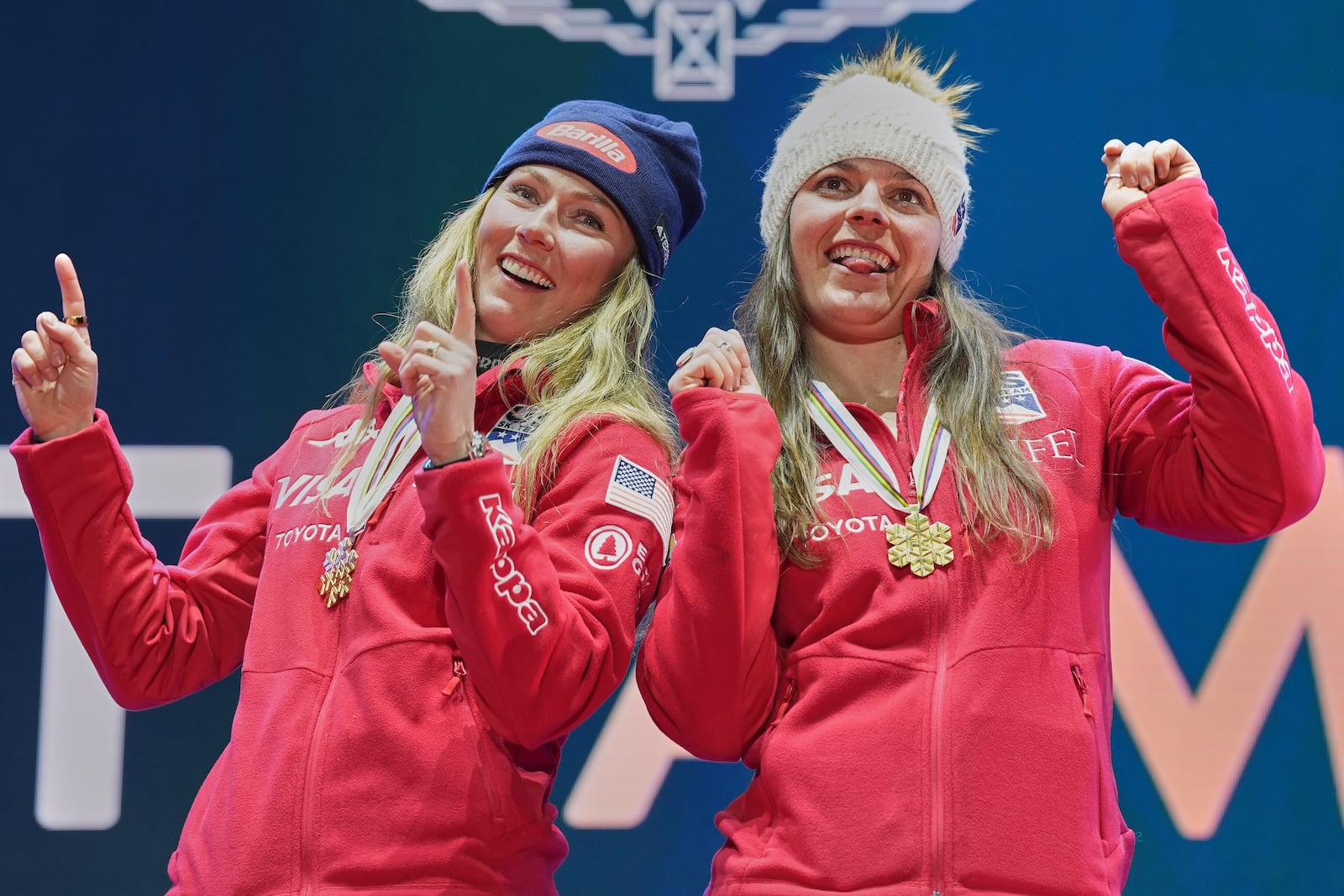 United States' Mikaela Shiffrin, left, and United States' Breezy Johnson listen celebrate as they wear their gold medals for a women's team combined event, at the Alpine Ski World Championships, in Saalbach-Hinterglemm, Austria, Tuesday, Feb. 11, 2025. (AP Photo/Giovanni Auletta)