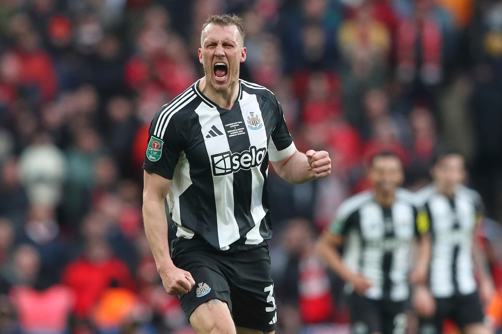 Newcastle's Dan Burn celebrates after scoring the opening goal during the EFL Cup final soccer match between Liverpool and Newcastle at Wembley Stadium in London, Sunday, March 16, 2025. (AP Photo/Scott Heppell)