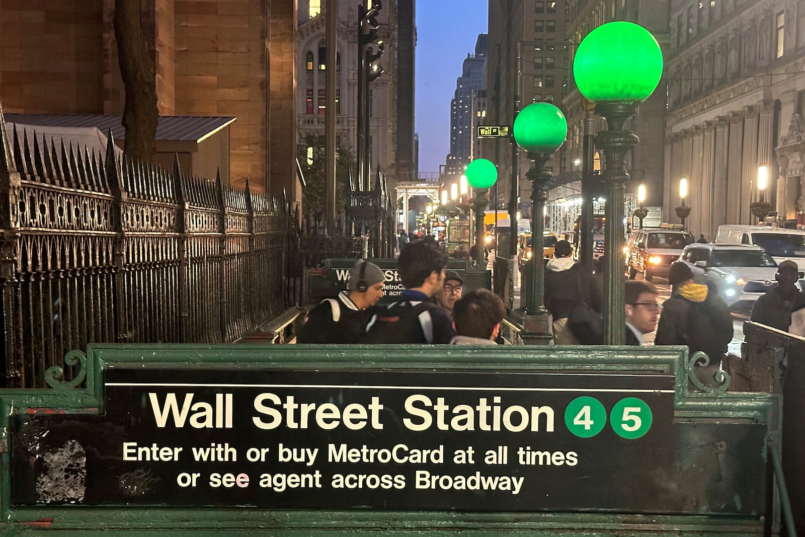 Commuters emerge from a Wall Street subway station in New York's Financial District on Wednesday, Oct. 30, 2024. (AP Photo/Peter Morgan)