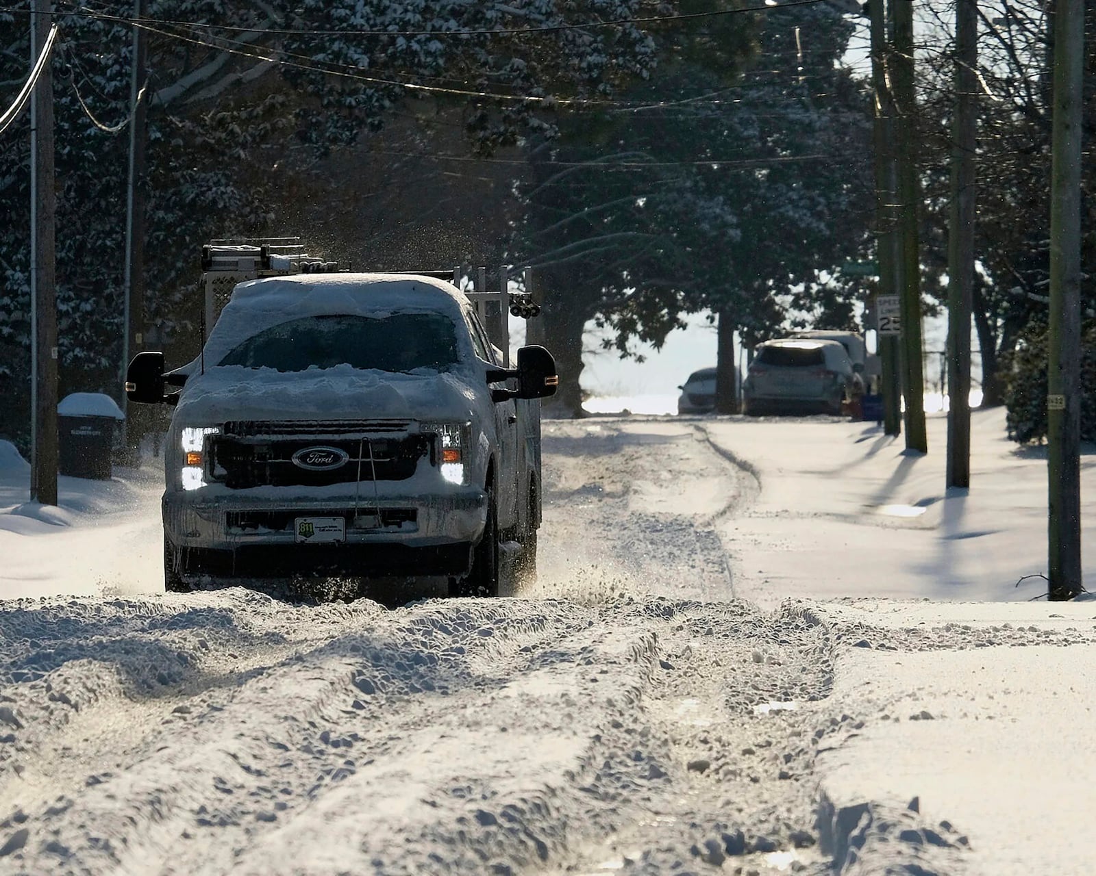 A Piedmont Natural Gas vehicle drives west through snow, Thursday, Feb. 20, 2025 in Elizabeth City, N.C. (Chris Day/The Daily Advance via AP)