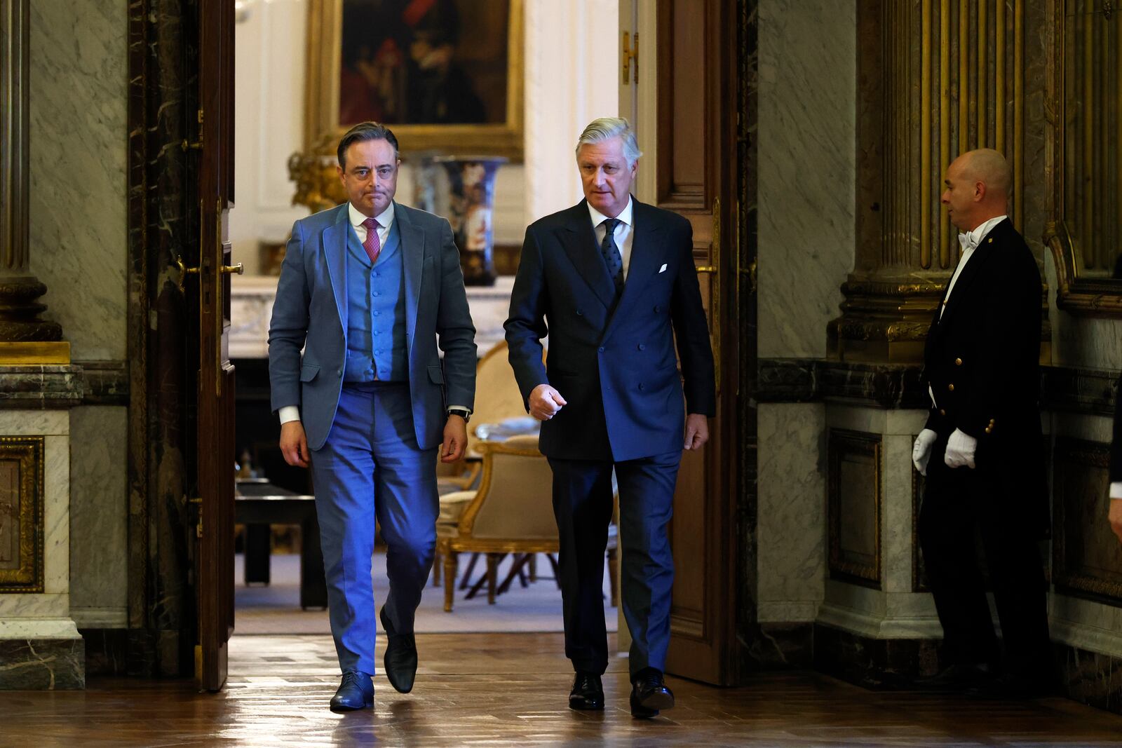 New Belgian Prime Minister Bart De Wever, left, walks with Belgium's King Philippe, center, during a swearing in ceremony for the new government at the Royal Palace in Brussels, Monday, Feb. 3, 2025. (AP Photo/Omar Havana)