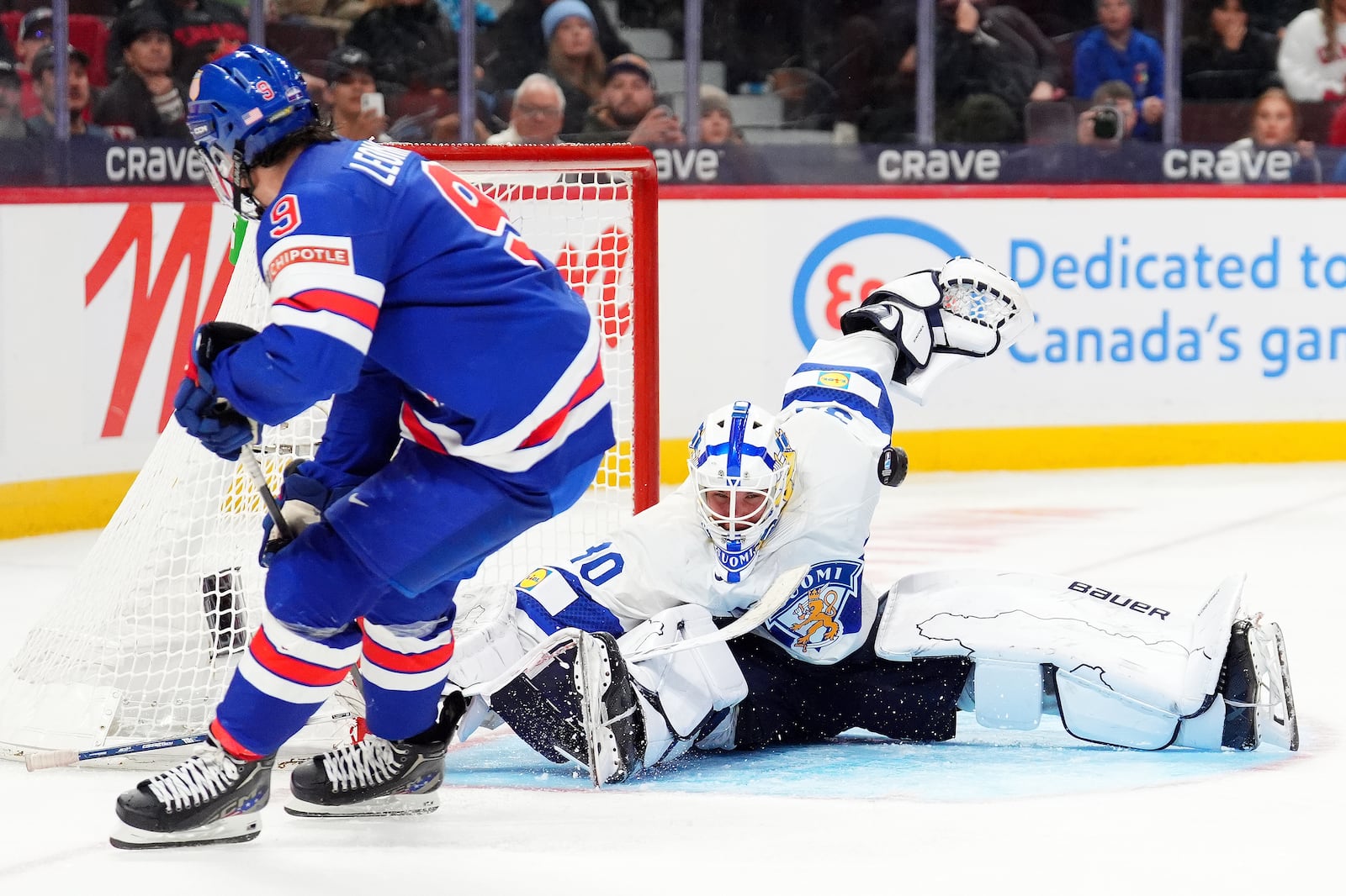 Finland goaltender Petteri Rimpinen (30) makes a save against United States forward Ryan Leonard (9) during third-period IIHF World Junior Hockey Championship gold medal game action in Ottawa, Ontario, Sunday, Jan. 5, 2025. (Sean Kilpatrick/The Canadian Press via AP)