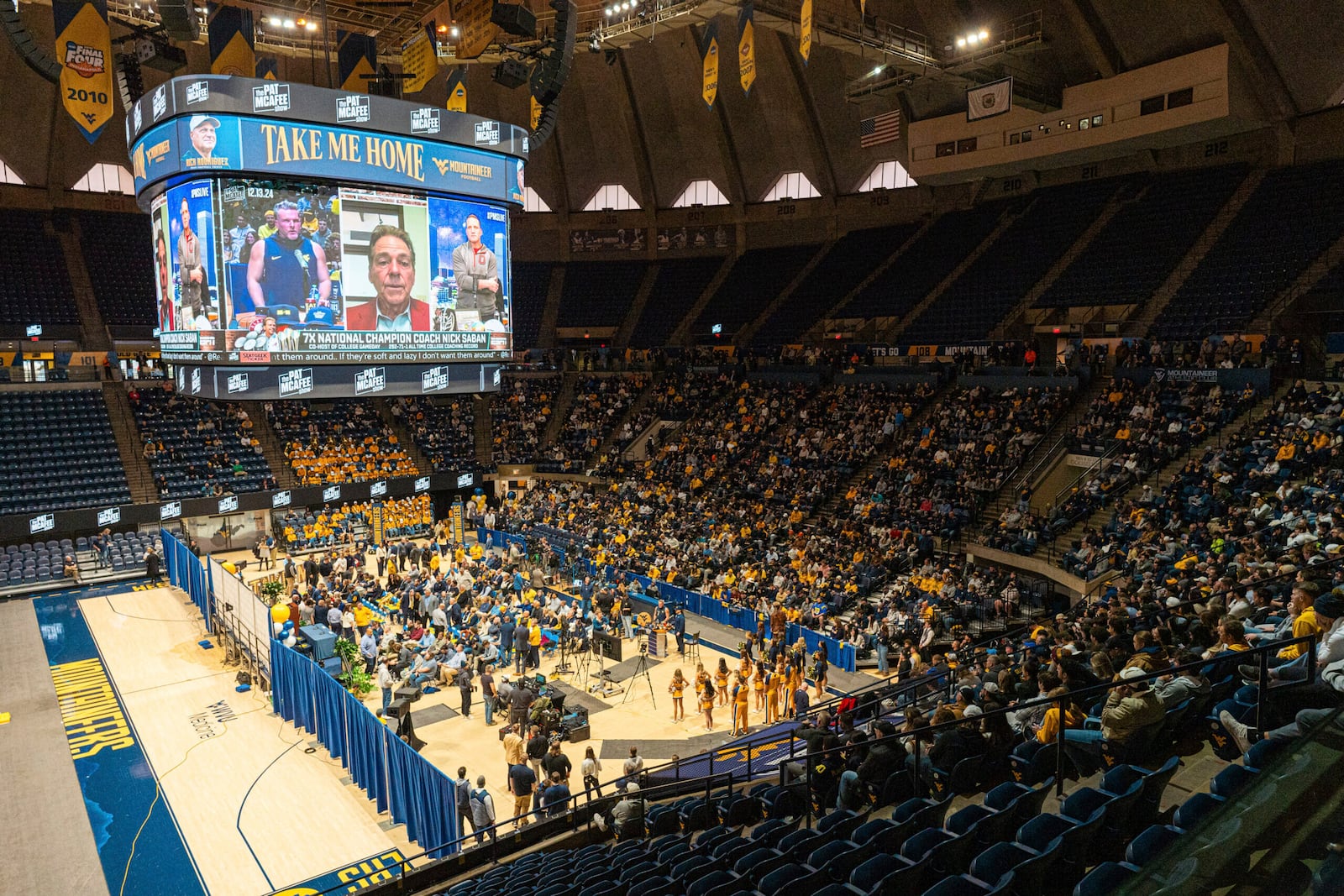 Fans fill the arena during an introductory NCAA college football news conference for West Virginia coach Rich Rodriguez, Friday, Dec. 13, 2024, in Morgantown, W.Va. (Benjamin Powell/The Dominion-Post via AP)