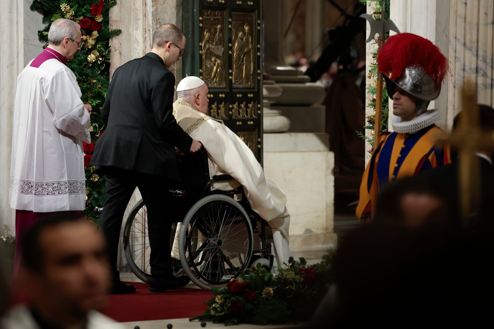 Pope Francis opens the Holy Door to mark the opening of the 2025 Catholic Holy Year, or Jubilee, in St. Peter's Basilica, at the Vatican, Dec. 24, 2024. (Remo Casilli/Pool Photo via AP)