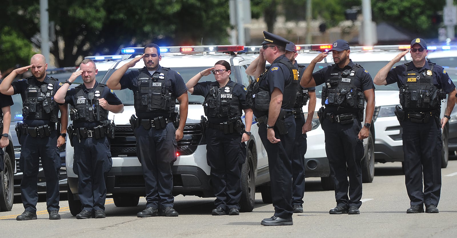 Members of the Dayton Police Department pay their respects to fallen Clark County deputy Matthew Yates, Monday July 25, 2022.  MARSHALL GORBY\STAFF