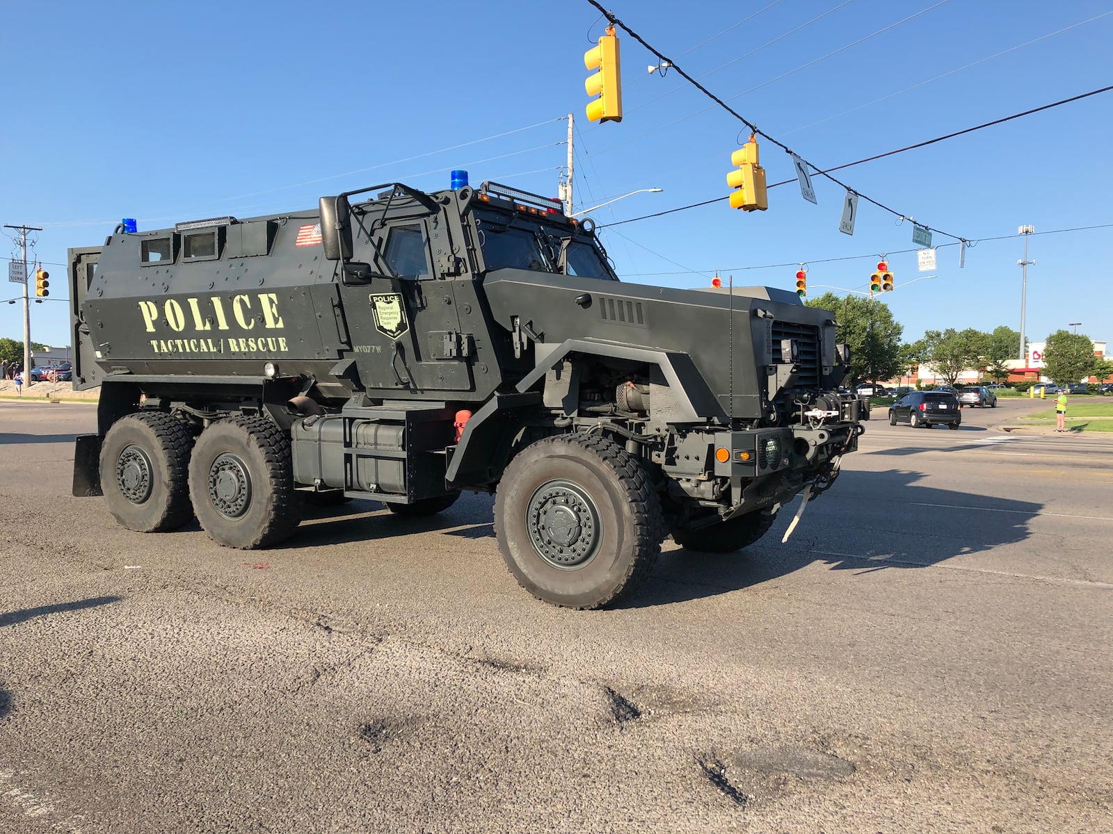 A Huber Heights Police tactical vehicle drives away from the protest on Old Troy Pike after police ordered the crowd to disburse. The crowd remained but tension dissipated when the vehicle and other officers left the scene.