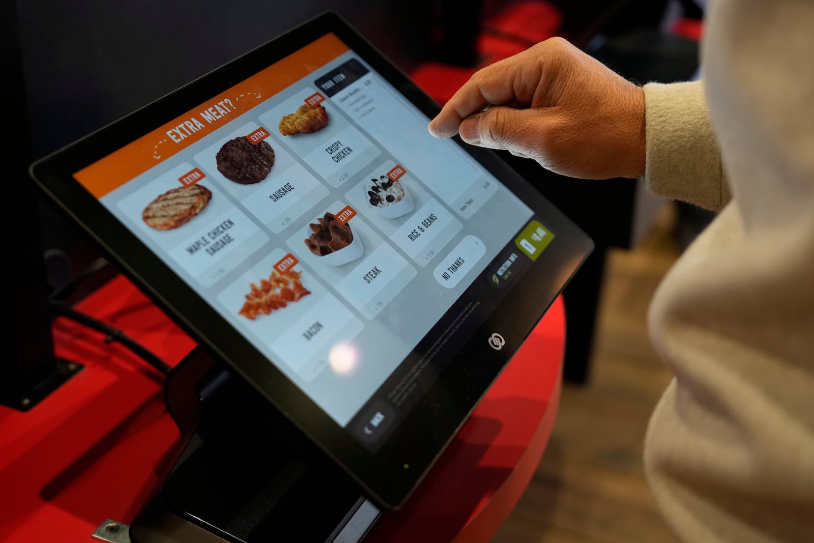 Brian Blair, of Akron, Ohio, enters his food order at a Sheetz convenience store, Thursday, Oct. 17, 2024, in Bethlehem, Pa. (AP Photo/Matt Slocum)