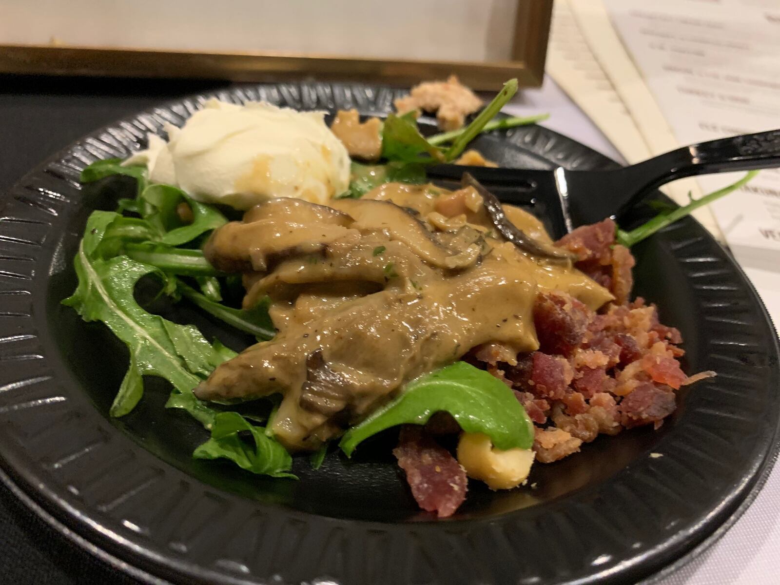 elé Bistro and Wine Bar served a warm mushroom salad with mascarpone, pancetta and toasted hazelnuts on a bed of arugula at the Miami Valley Restaurant Association’s Sneak Peek to Winter Restaurant Week. CONTRIBUTED/ALEXIS LARSEN