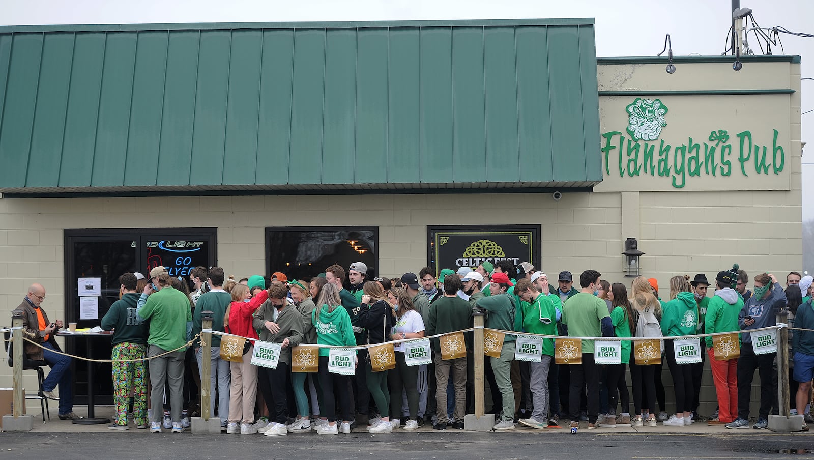 Patrons line up for St. Patrick's Day outside Flanagan's Pub early Wednesday morning, March 17, 2021. MARSHALL GORBY\STAFF