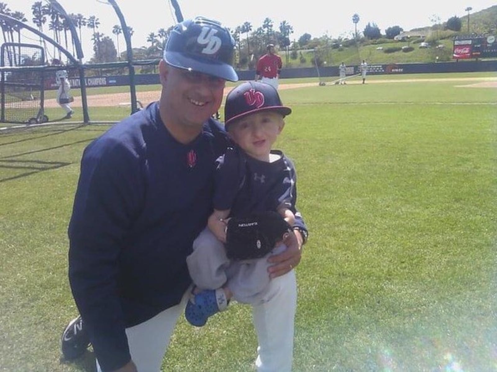 A young Daniel “Danny McCarty sits on the knee of Tony Vittorio when Vittorio coached at the University of Dayton from 2000 through 2017.(Contributed Photo)