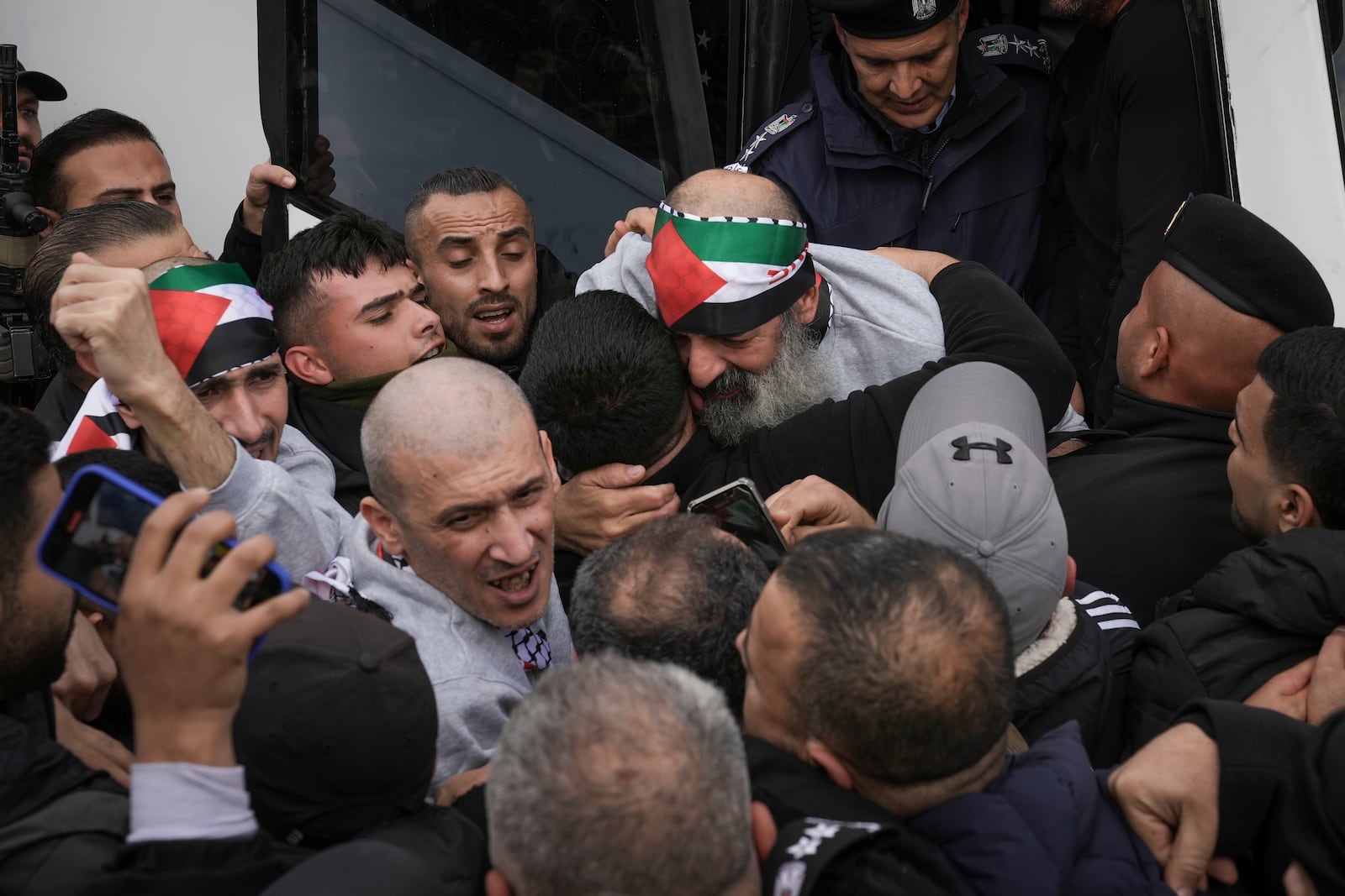 Crowd greets Palestinian prisoners as the exit a Red Cross bus after being released from Israeli prison following a ceasefire agreement between Israel and Hamas, in the West Bank city of Ramallah, Saturday Feb. 1, 2025. (AP Photo/Mahmoud Illean)