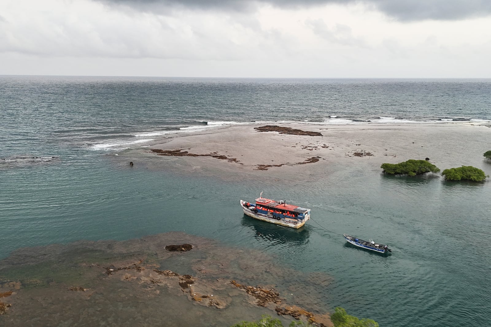 A boat transporting migrants departs the Caribbean coastal village of Miramar, Panama, for the Colombian border, Thursday, Feb. 27, 2025, as migrants return from southern Mexico after abandoning hopes of reaching the U.S. in a reverse flow triggered by the Trump administration's immigration crackdown. (AP Photo/Matias Delacroix)