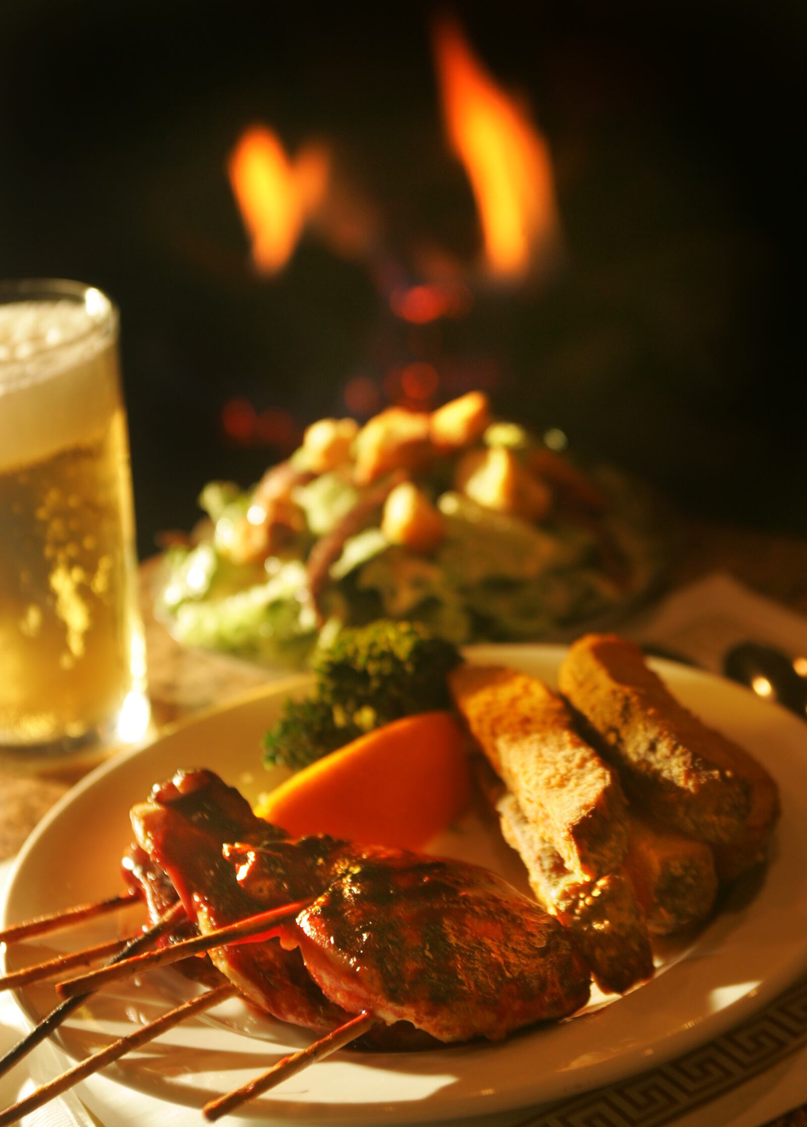 Photographed in front of the fireplace is the Chicken Royale, Broasted Potatoes, and Ceaser Salad at the Grub Steak's new location on 2098 S. Alex Rd., West Carrollton. Photo by Jim Witmer