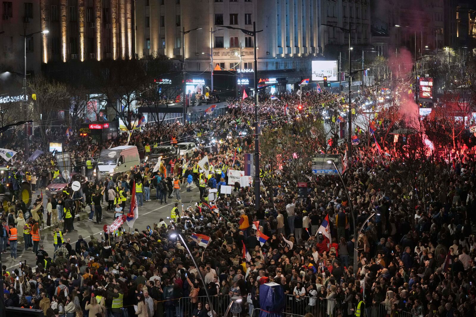 People welcome protesters from provinces who have arrived ahead of a major rally this weekend in downtown Belgrade, Serbia, Friday, March 14, 2025. (AP Photo/Darko Vojinovic)