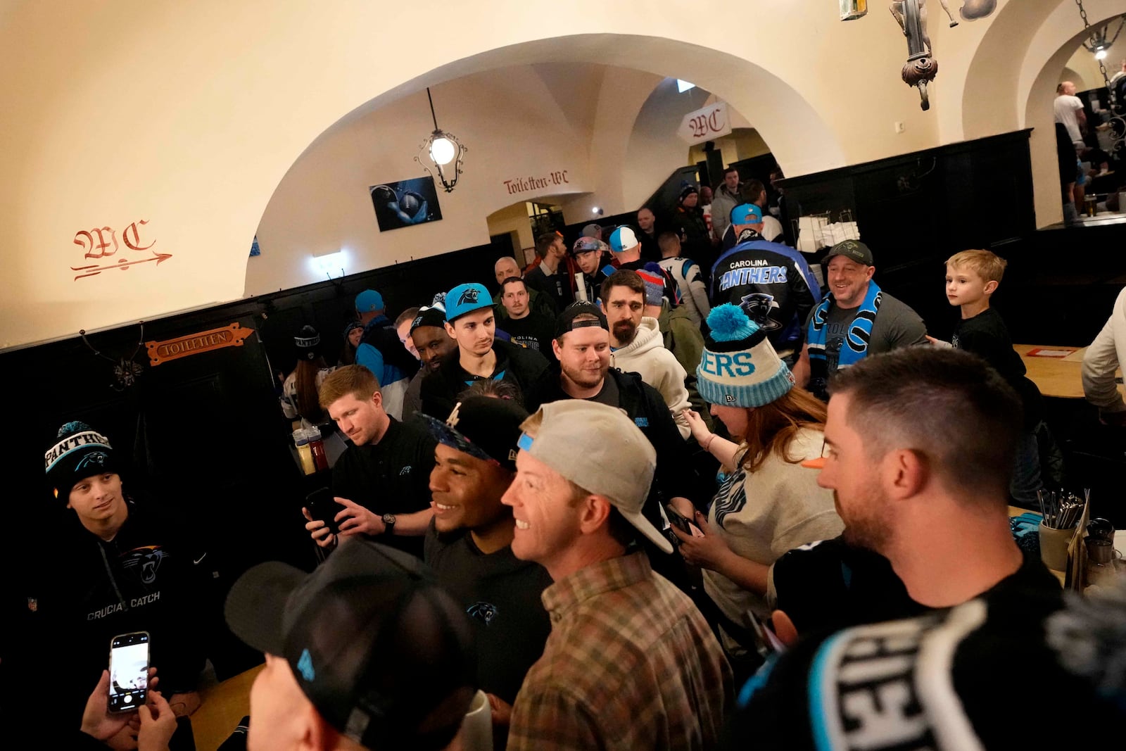 Carolina Panthers supporters enjoy the day inside the traditional 'Augustiner' beer house in Munich, Germany, Saturday, Nov. 9, 2024 ahead of the NFL match between the Carolina Panthers and the New York Giants in Munich on Sunday. (AP Photo/Matthias Schrader)