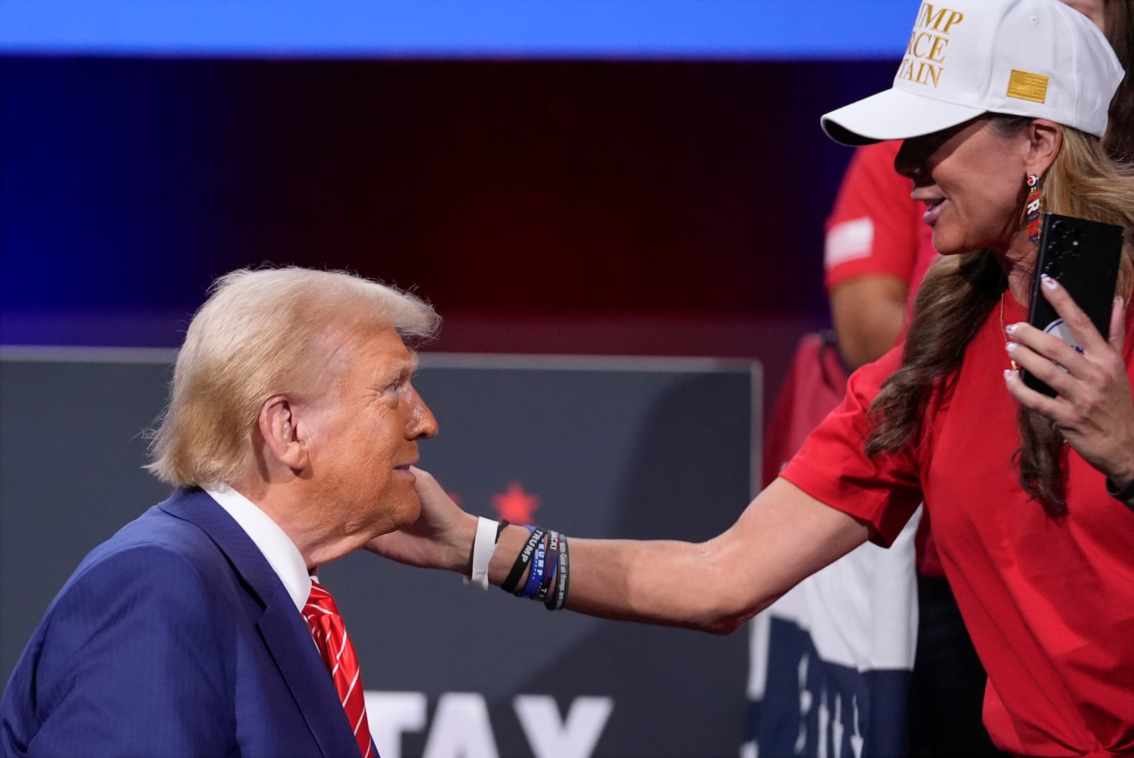 A supporter greets Republican presidential nominee former President Donald Trump after a campaign event at the Cobb Energy Performing Arts Centre, Tuesday, Oct. 15, 2024, in Atlanta. (AP Photo/Alex Brandon)