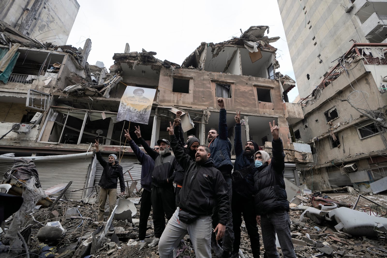 Hezbollah supporters cheer as they return to Dahiyeh, in Beirut, Lebanon, following a ceasefire between Israel and Hezbollah that went into effect on Wednesday, Nov. 27, 2024. (AP Photo/Bilal Hussein)