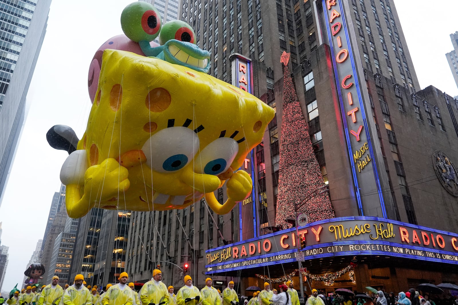 Handlers guide the SpongeBob SquarePants balloon down Sixth Avenue during the Macy's Thanksgiving Day Parade, Thursday, Nov. 28, 2024, in New York. (AP Photo/Julia Demaree Nikhinson)