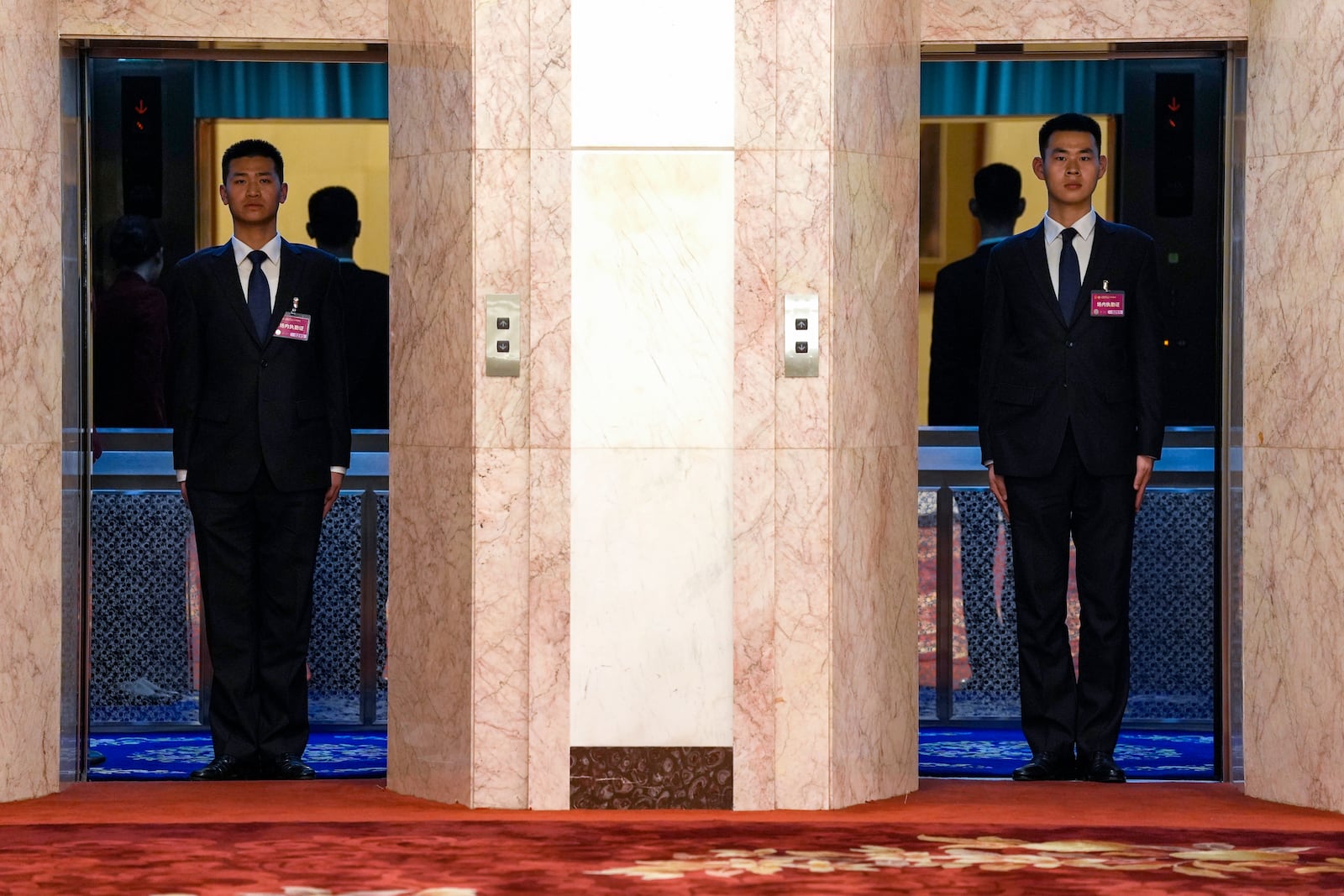 Security guards block off lifts after the closing ceremony of the National People's Congress held at the Great Hall of the People in Beijing, Tuesday, March 11, 2025. (AP Photo/Ng Han Guan)