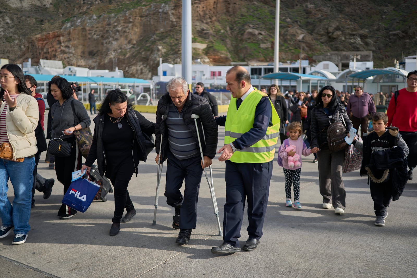 Passengers board a regularly scheduled ferry to Athens' port of Piraeus, after a spike in seismic activity raised concerns about a potentially powerful earthquake in Santorini, southern Greece, Monday, Feb. 3, 2025. (AP Photo/Petros Giannakouris)