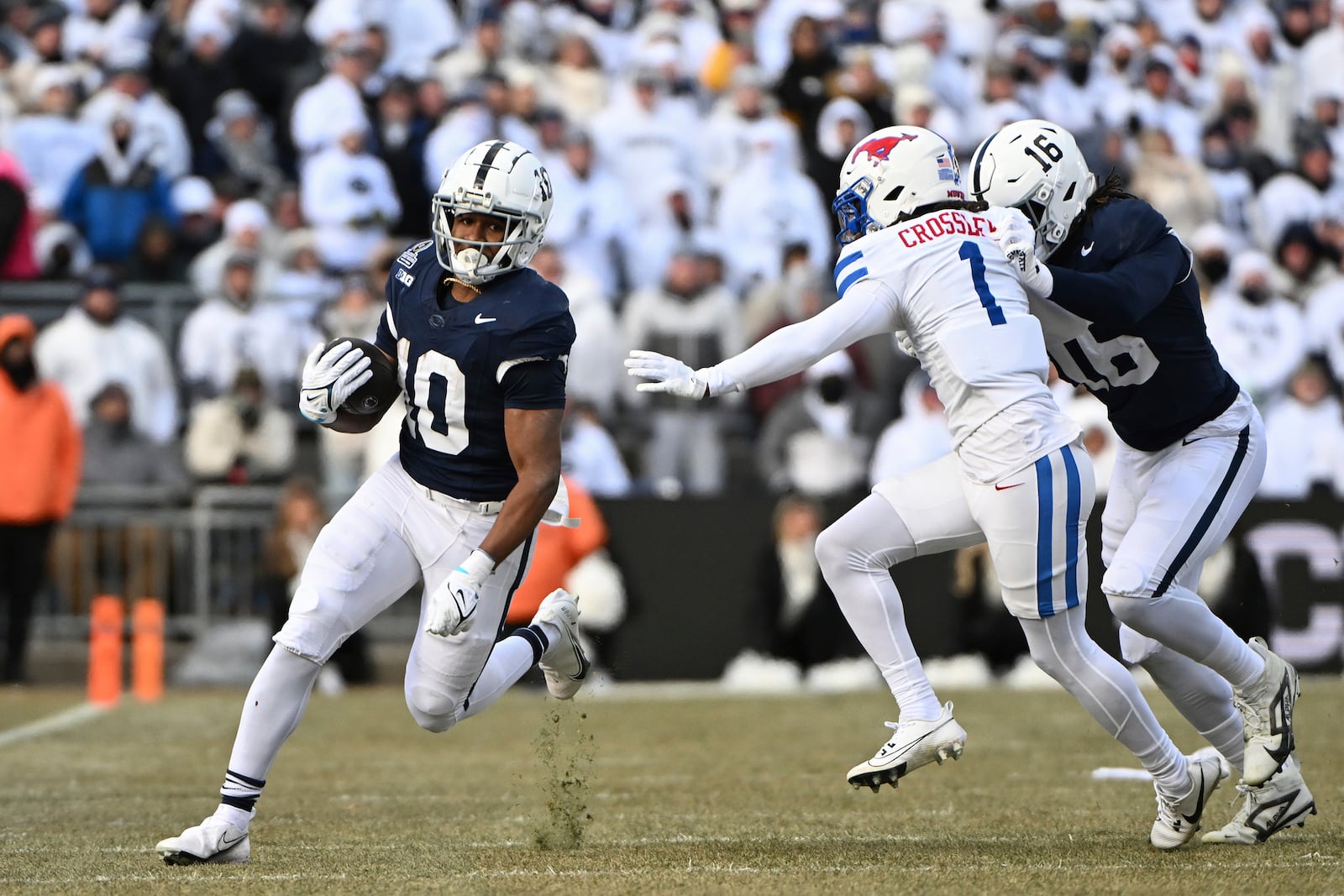 Penn State running back Nicholas Singleton looks to elude SMU safety Brandon Crossley (1) during the first half in the first round of the College Football Playoff, Saturday, Dec. 21, 2024, in State College, Pa. (AP Photo/Barry Reeger)