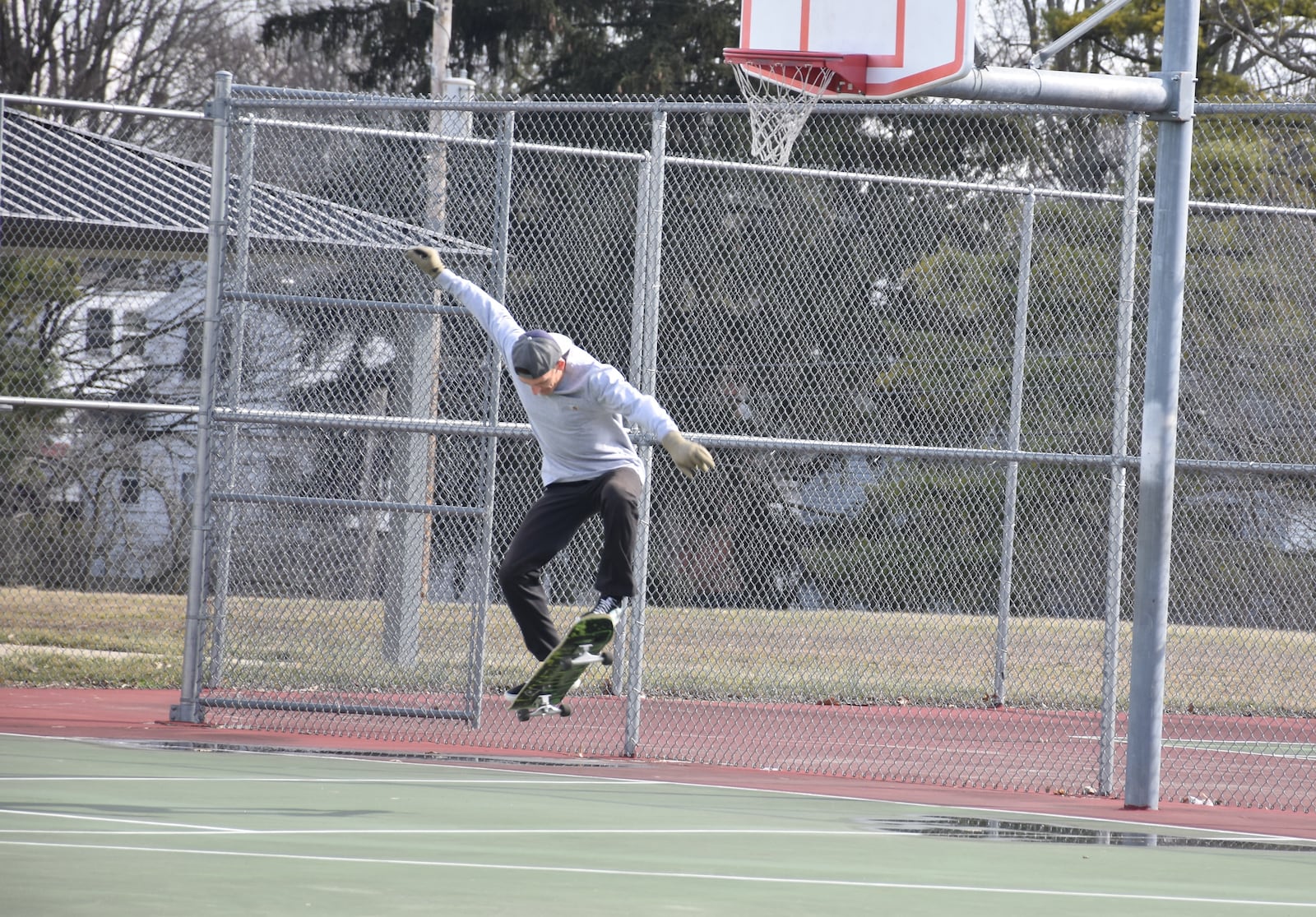 JD performs a trick on his skateboard on the tennis court at Belmont Park in southeast Dayton. The Dayton resident said he'd like to see the city install a skatepark or skating area at Belmont Park. CORNELIUS FROLIK / STAFF