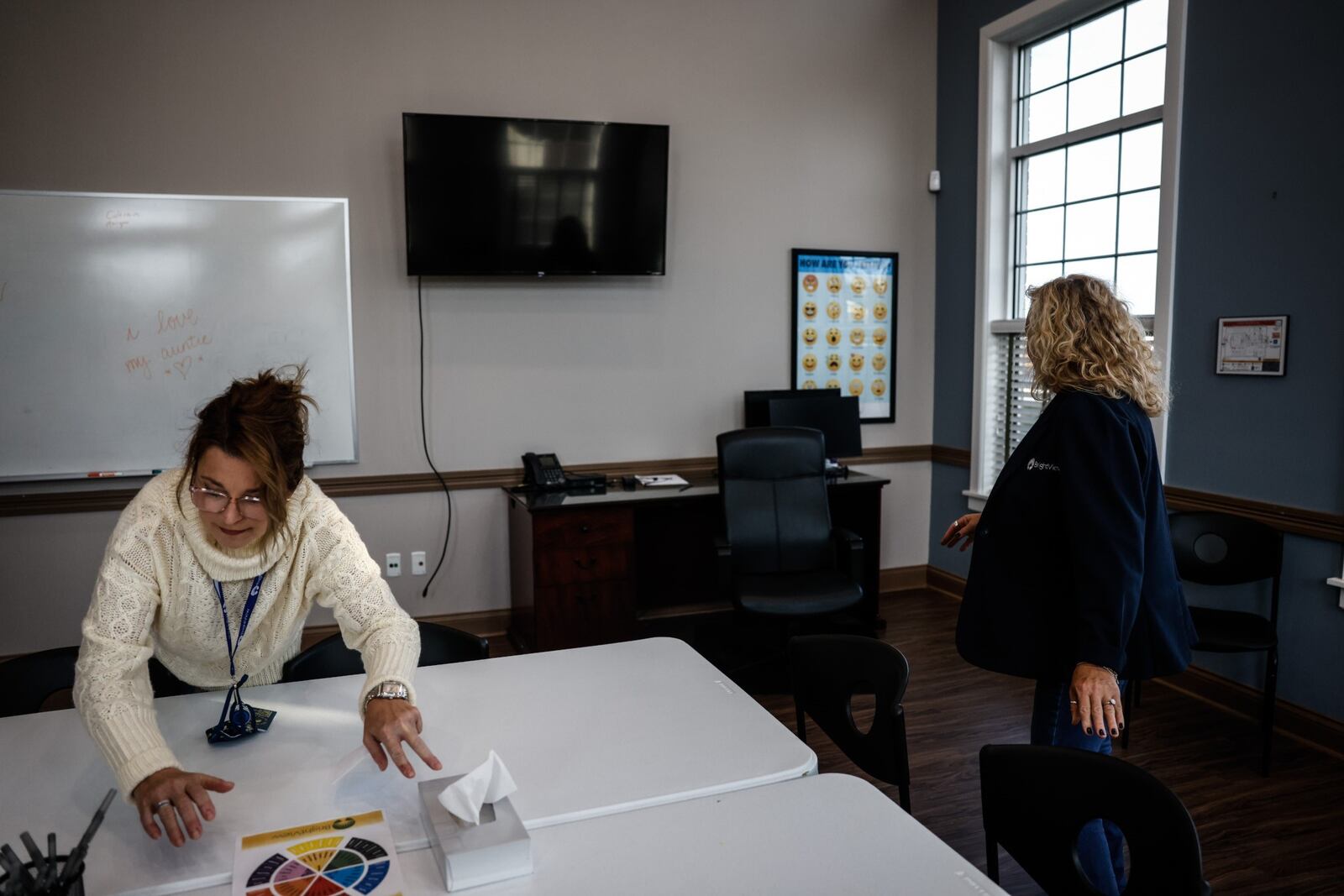 Angie Ficco, left and Renena Hale, both community outreach managers for BrightView, straighten up a meeting room at the facility in Washington Twp. JIM NOELKER/STAFF