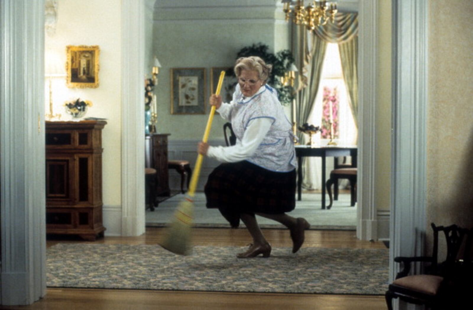 Robin Williams brooms in a scene from the film 'Mrs. Doubtfire', 1993. (Photo by 20th Century-Fox/Getty Images)