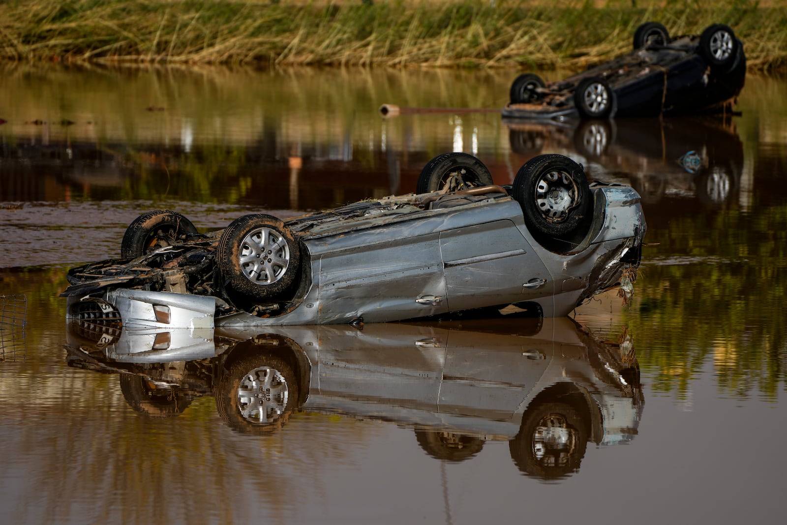 Flooded cars are piled up in Utiel, Spain, Wednesday, Oct. 30, 2024. (AP Photo/Manu Fernandez)