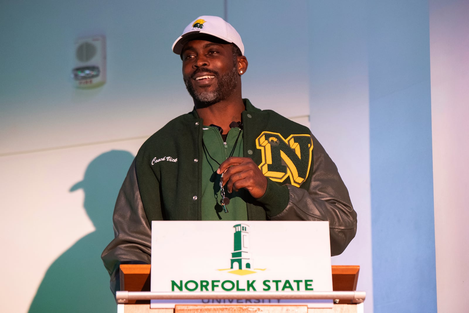 Michael Vick holds a whistle around his neck after he is introduced as the head coach of the Norfolk State football team during a press conference on Monday, Dec. 23, 2024 in Norfolk, Va. (AP Photo/Mike Caudill)