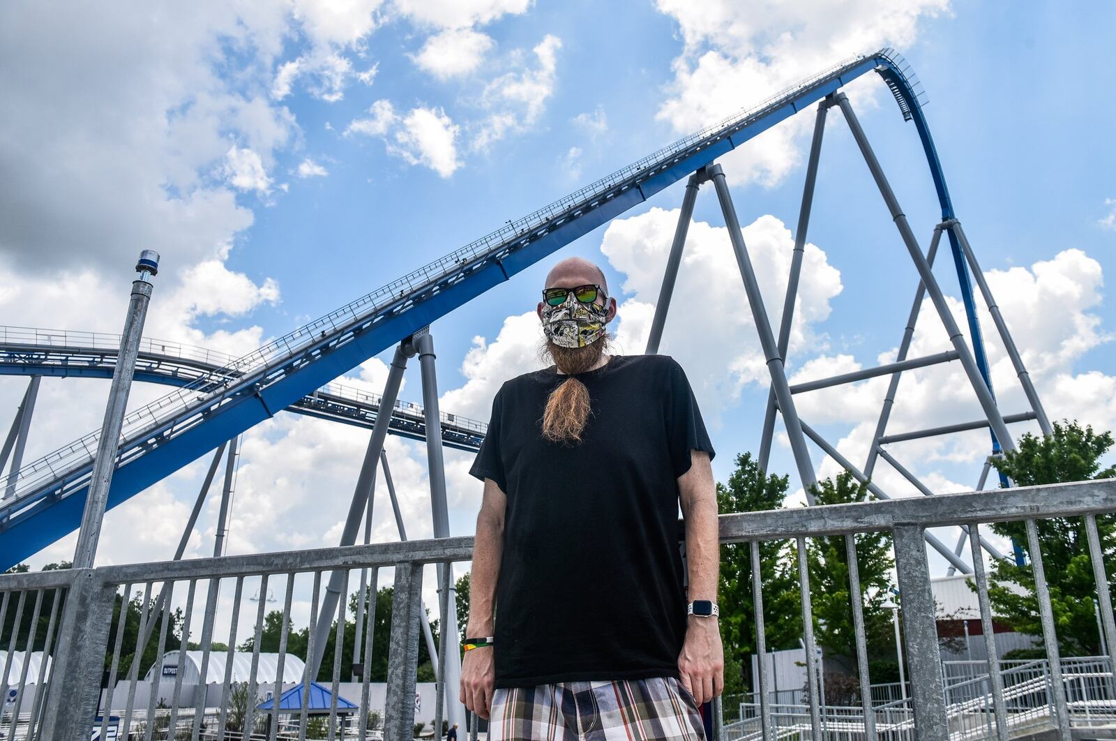 Coaster enthusiast Jared Ream stands with the new Orion giga coaster in the background on media day on July 1 at Kings Island in Mason. Ream lost 190 pounds, motivated by his desire to ride this coaster. NICK GRAHAM / STAFF