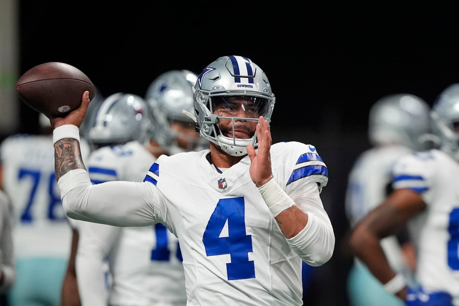 Dallas Cowboys quarterback Dak Prescott (4) warms up before an NFL football game against the Atlanta Falcons, Sunday, Nov. 3, 2024, in Atlanta. (AP Photo/ Brynn Anderson)