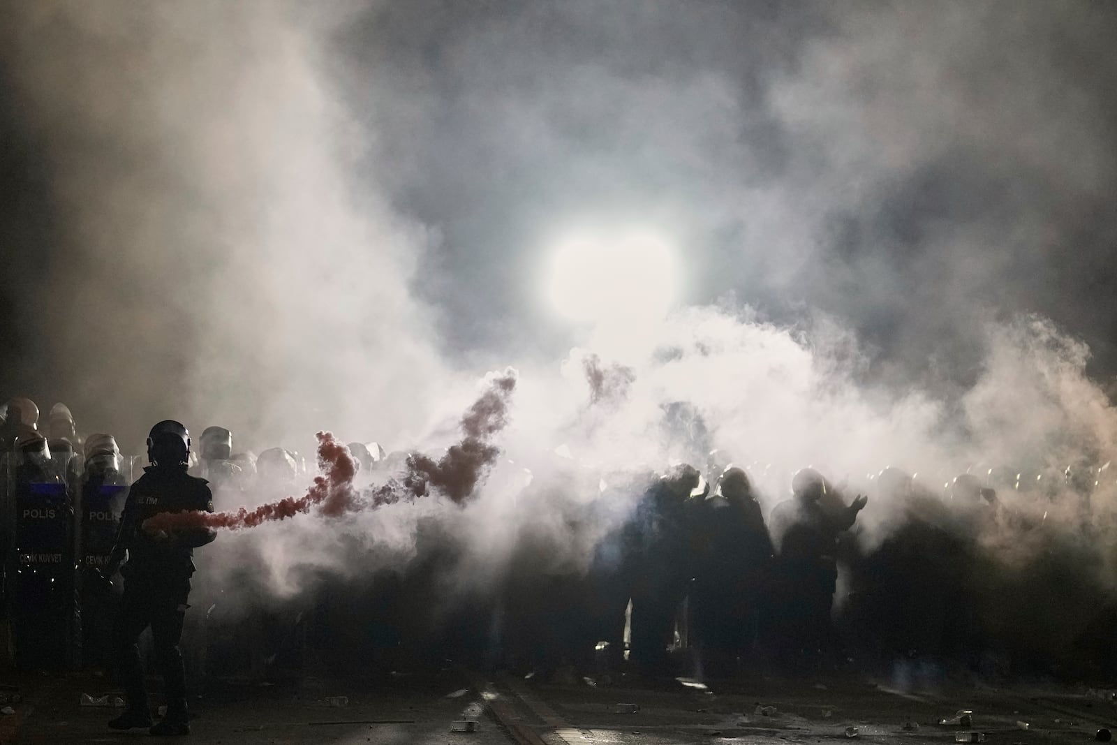 Riot police clash with protesters during a protest against the arrest of Istanbul's Mayor Ekrem Imamoglu, in Istanbul, Turkey, Saturday, March 22, 2025. (AP Photo/Khalil Hamra)