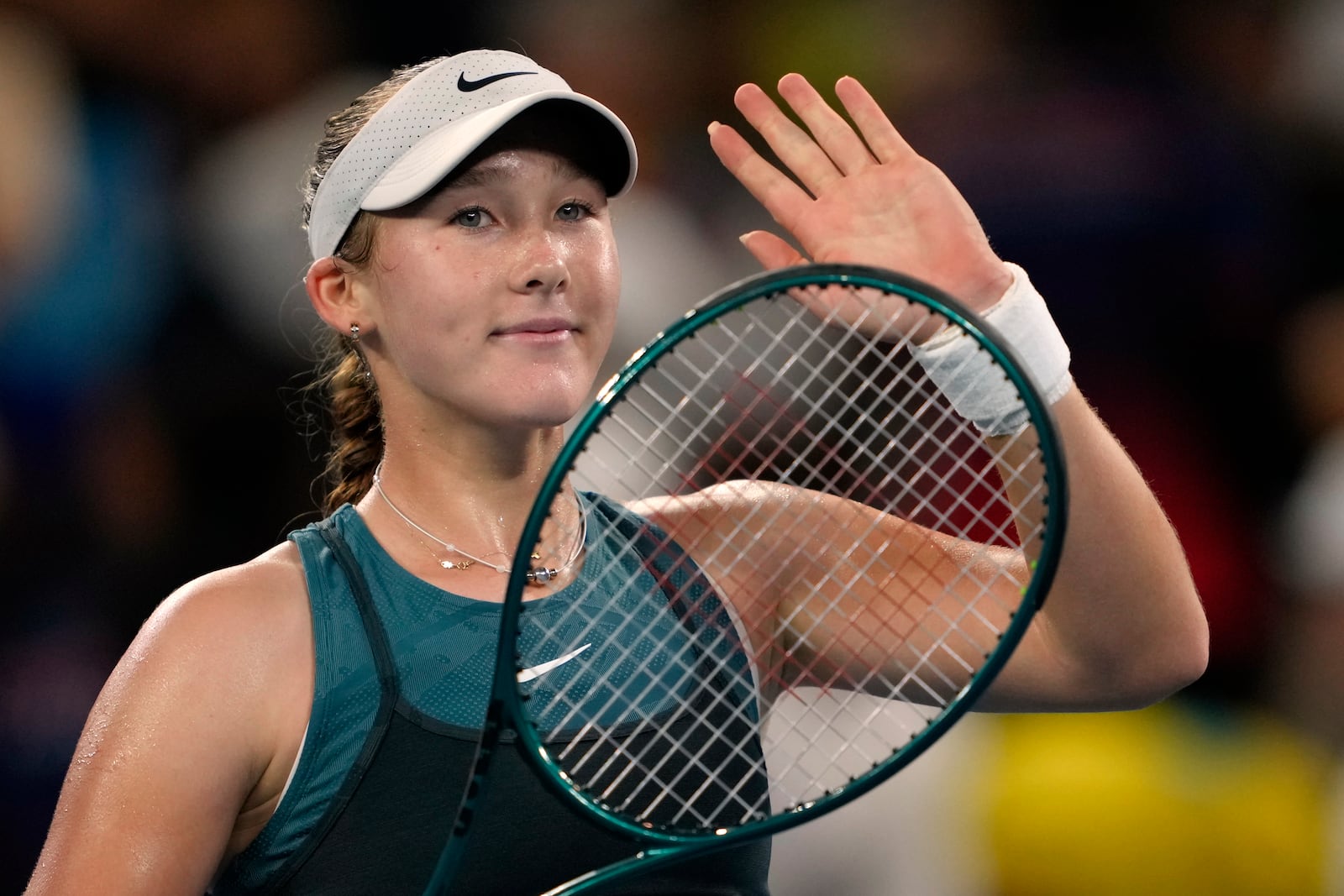 Mirra Andreeva of Russia waves after defeating Marie Bouzkova of the Czech Republic during their first round match at the Australian Open tennis championship in Melbourne, Australia, Sunday, Jan. 12, 2025. (AP Photo/Ng Han Guan)