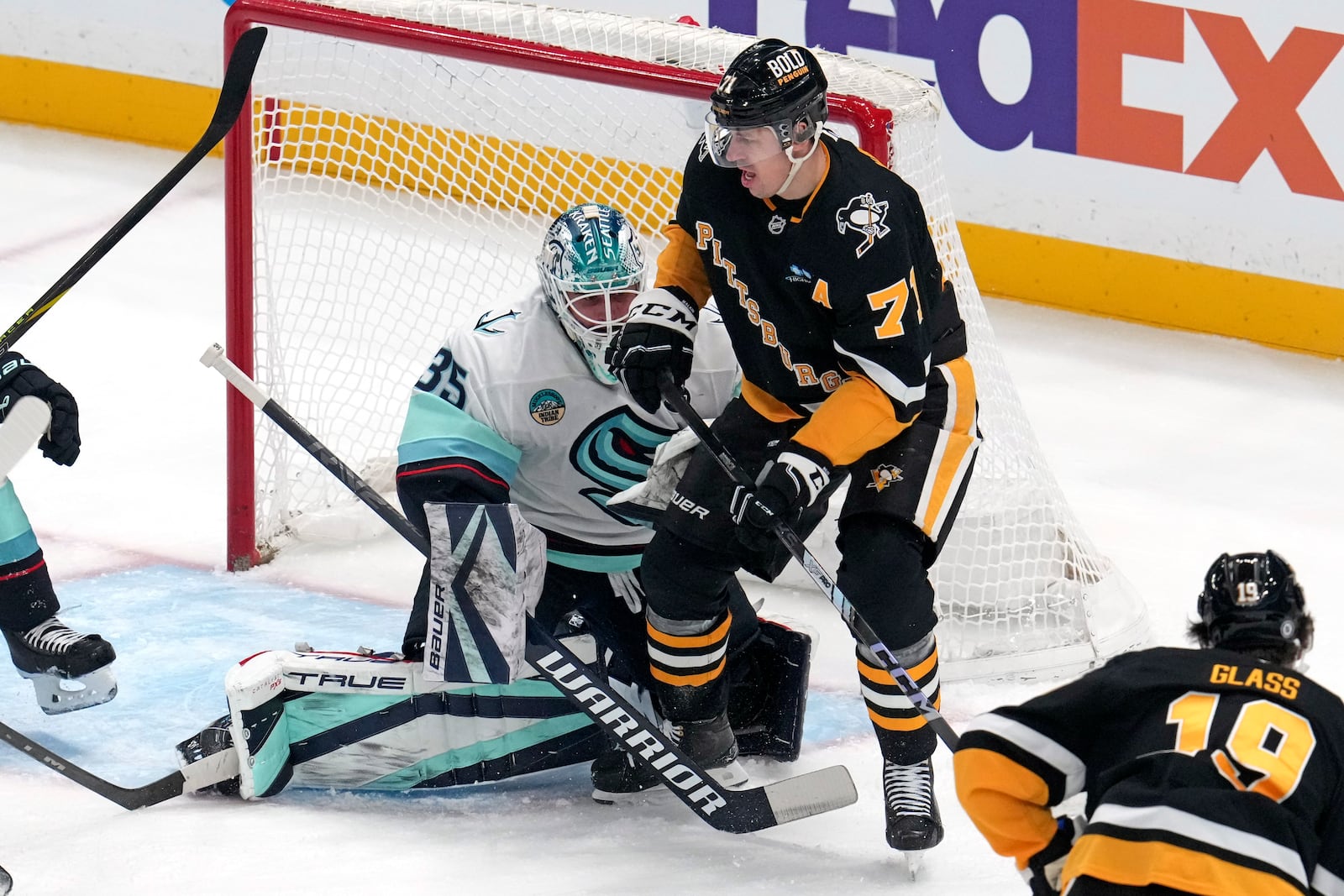 Pittsburgh Penguins' Evgeni Malkin screens Seattle Kraken goaltender Joey Daccord (35) during the first period of an NHL hockey game in Pittsburgh, Tuesday, Jan. 14, 2025. (AP Photo/Gene J. Puskar)