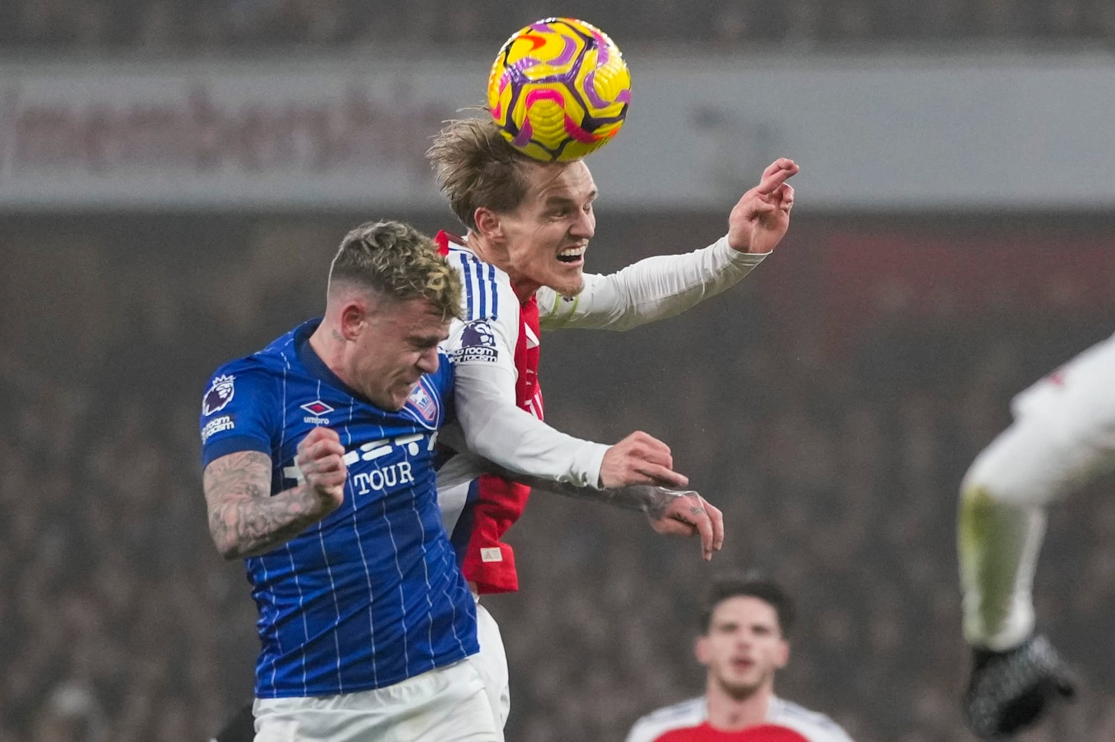 Arsenal's Martin Odegaard wins a header against Ipswich Town's Sammie Szmodics during the English Premier League soccer match between Arsenal and Ipswich at the Emirates Stadium in London, Friday, Dec. 27, 2024. (AP Photo/Kin Cheung)